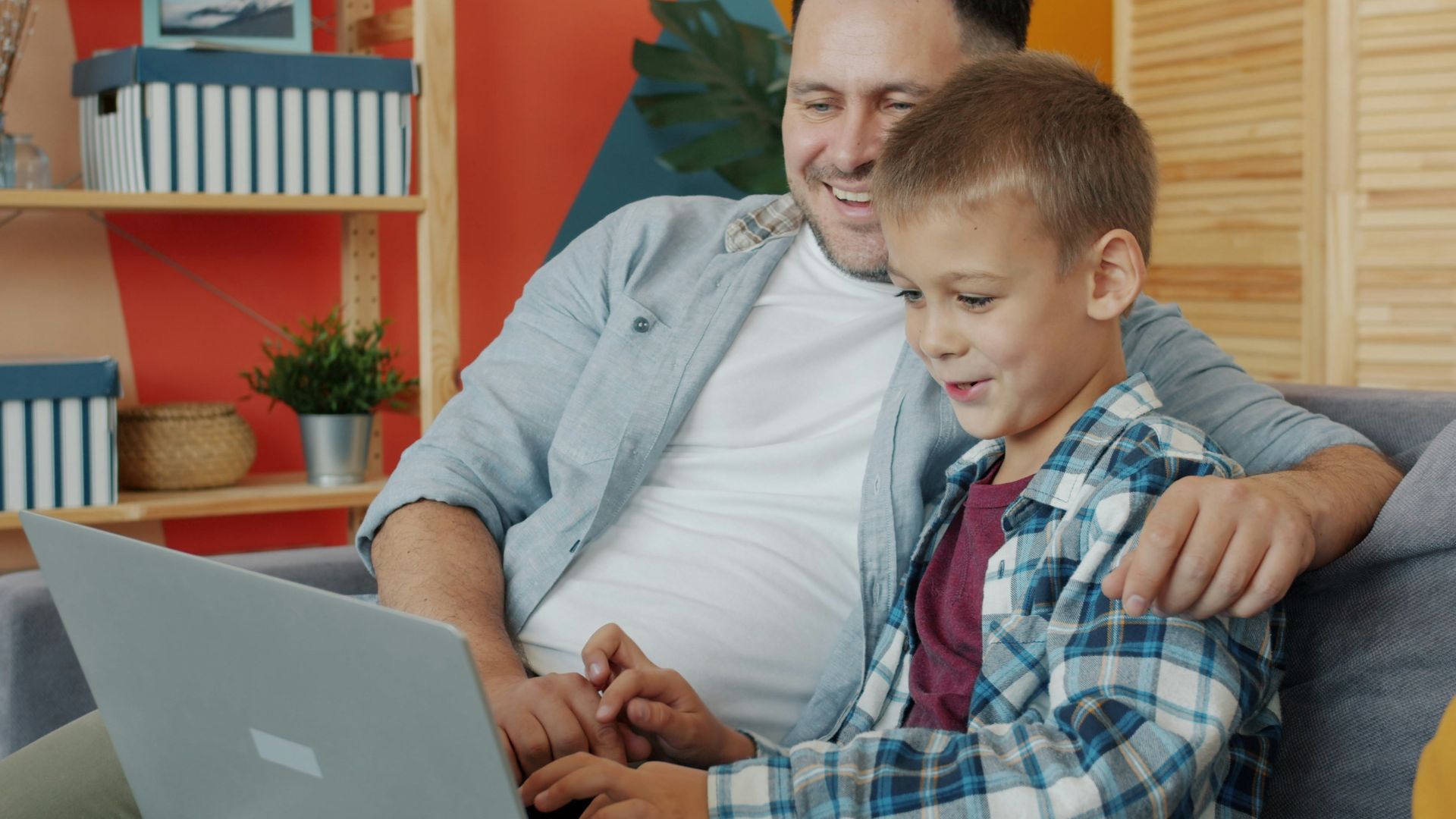 Father and son looking at laptop together