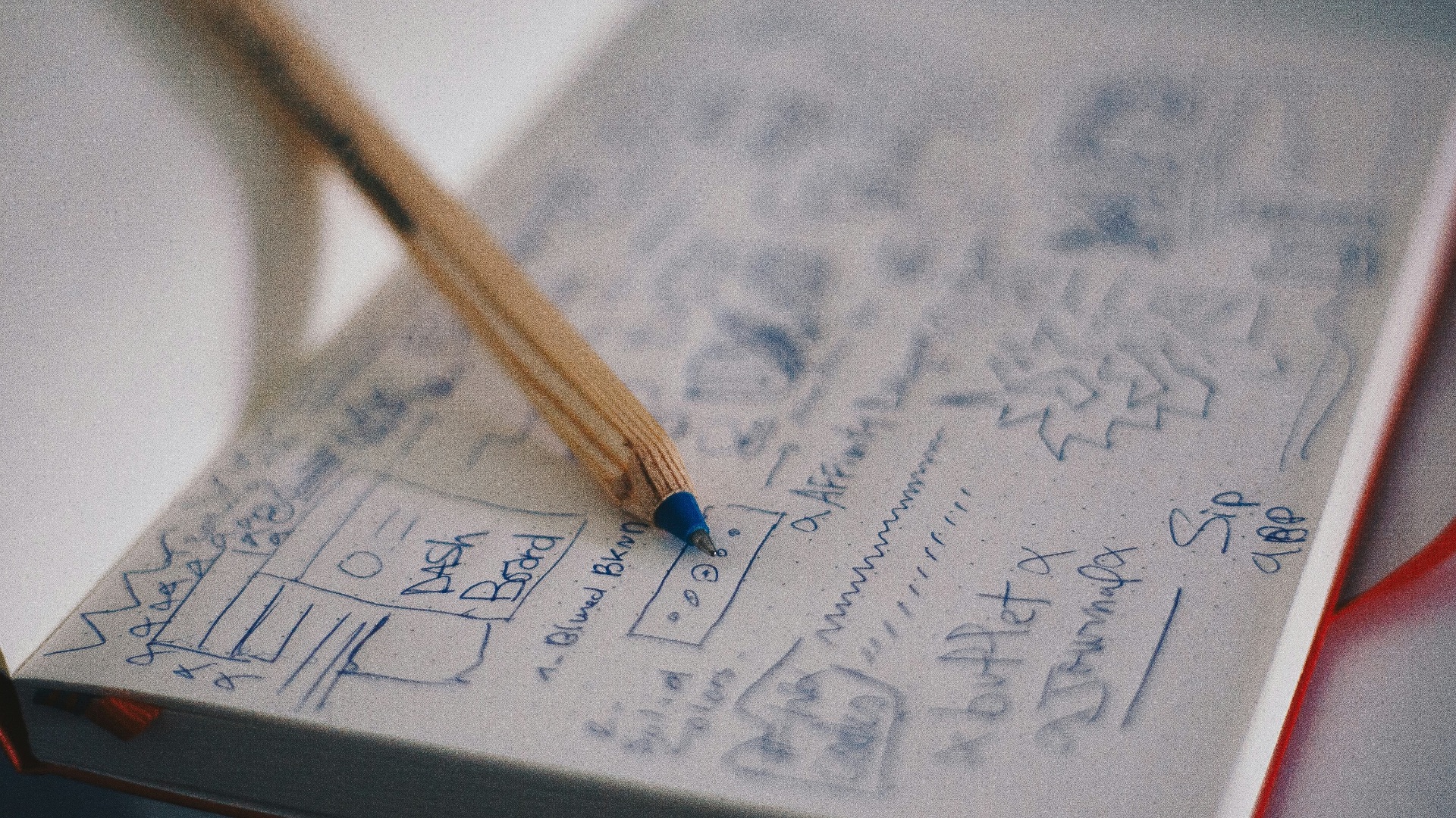 blue ballpoint pen on white notebook