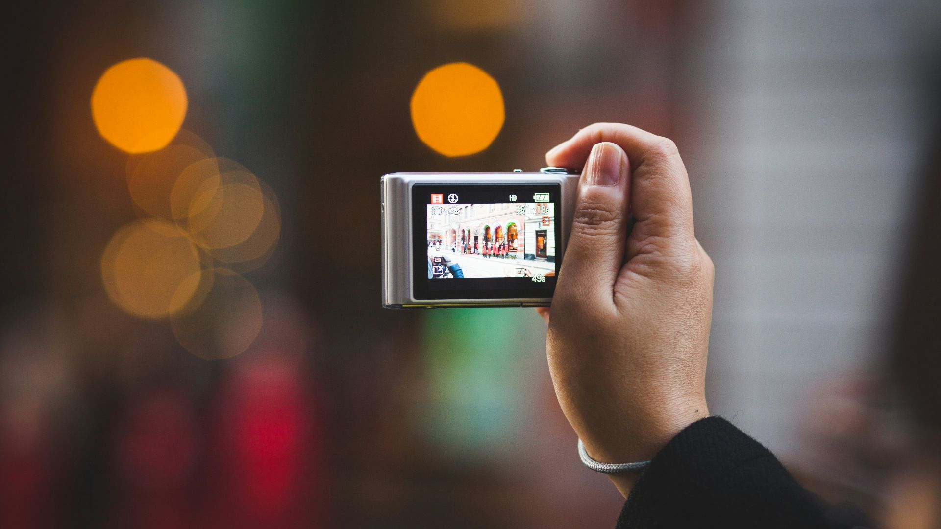 person holding digital camera