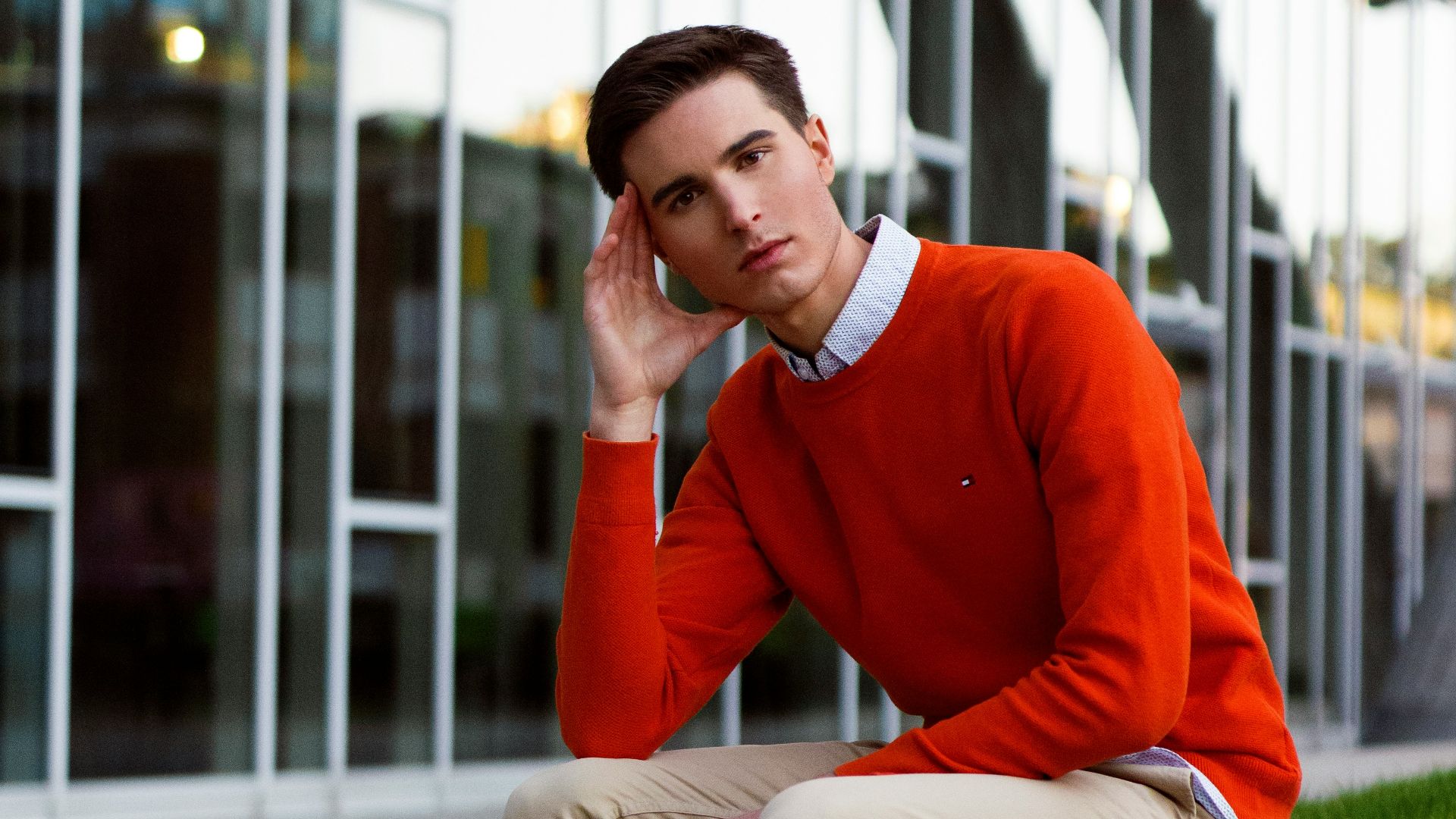 a man sitting on a bench in front of a building