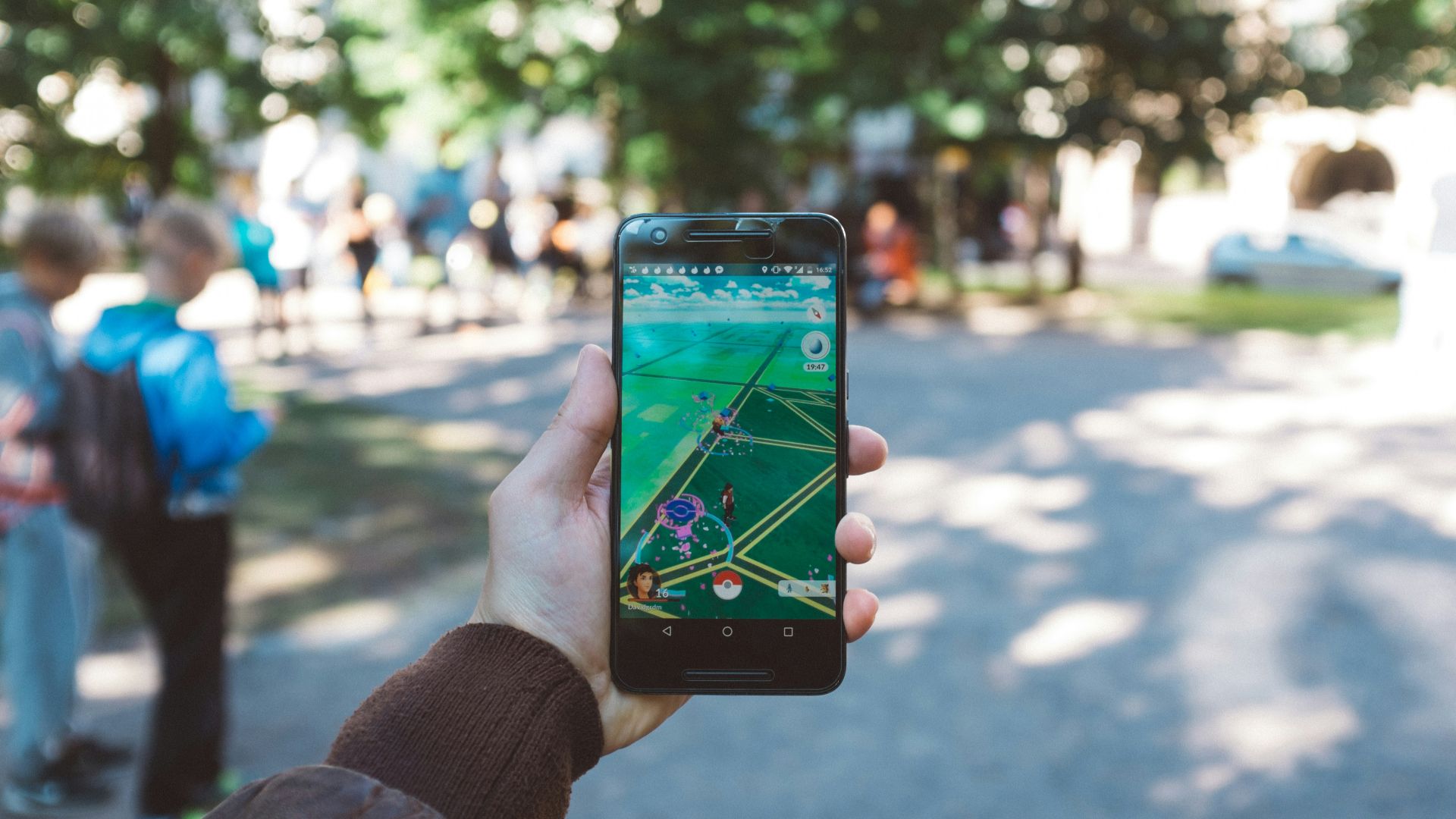 person playing Pokemon Go during daytime