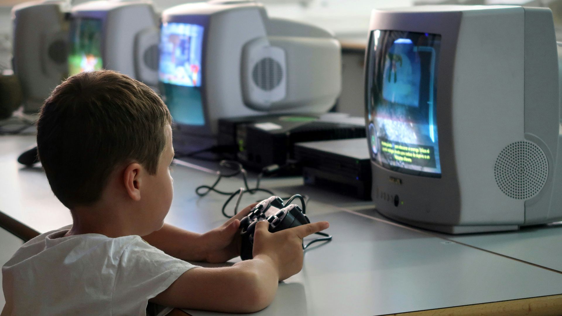 a young boy playing a video game on a nintendo wii