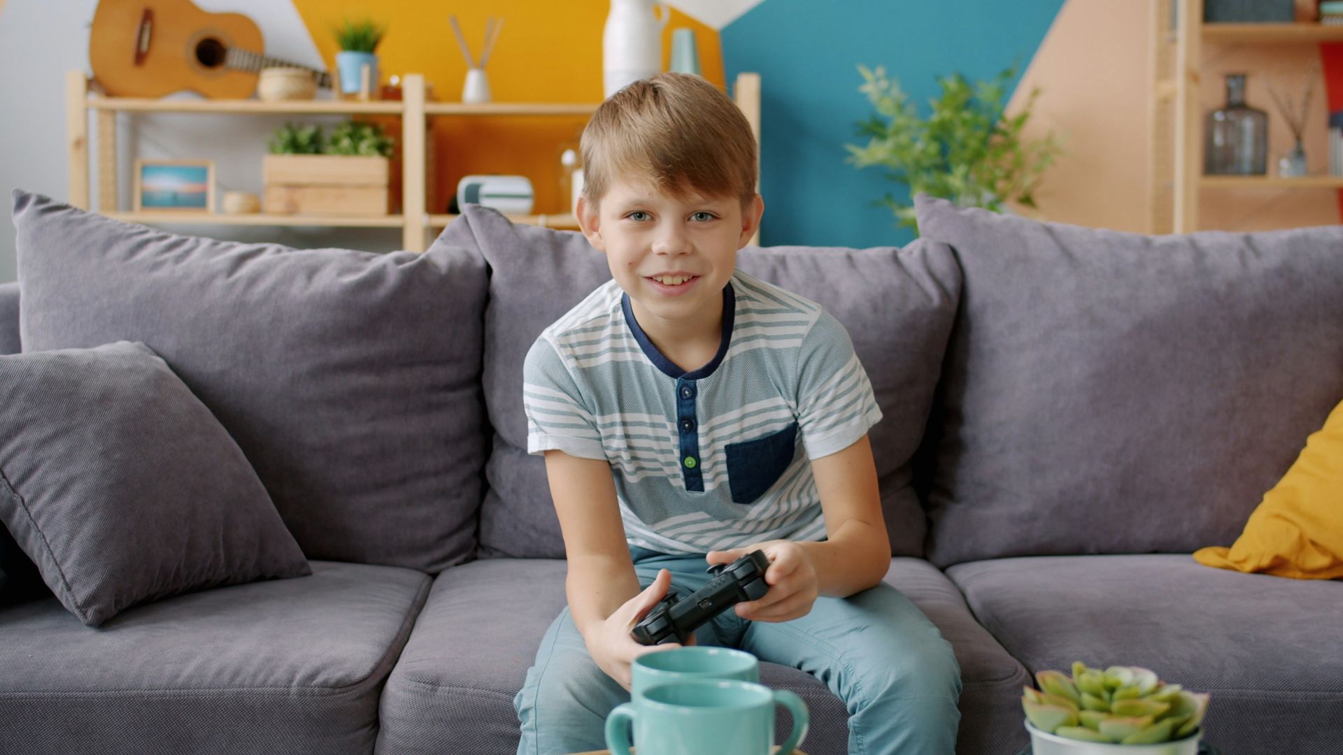 Boy playing video games on couch