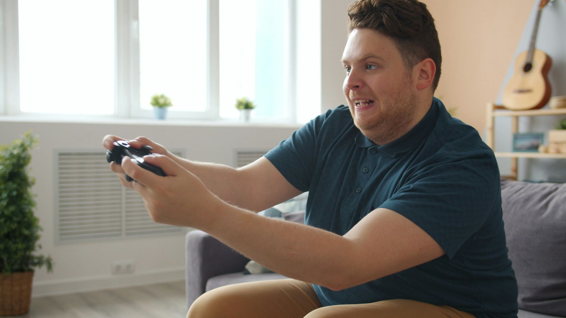 Man playing video games on a couch