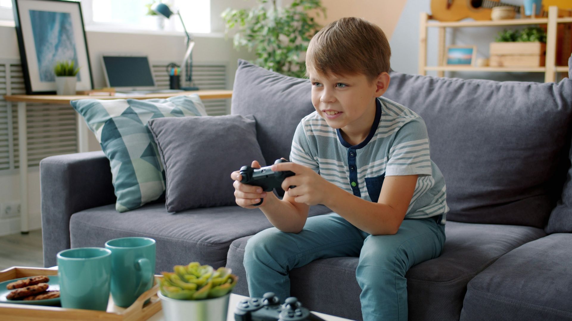 Boy playing video games on couch