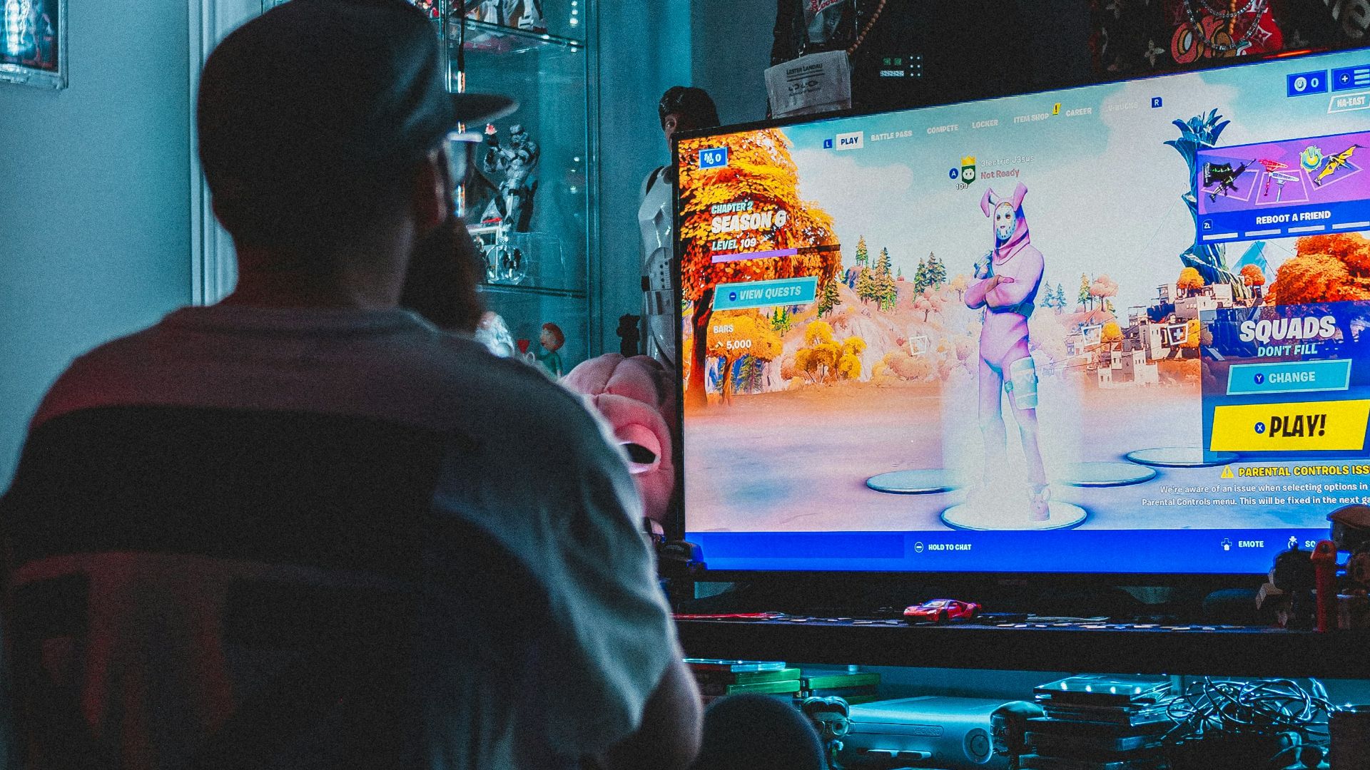 man in red shirt watching tv