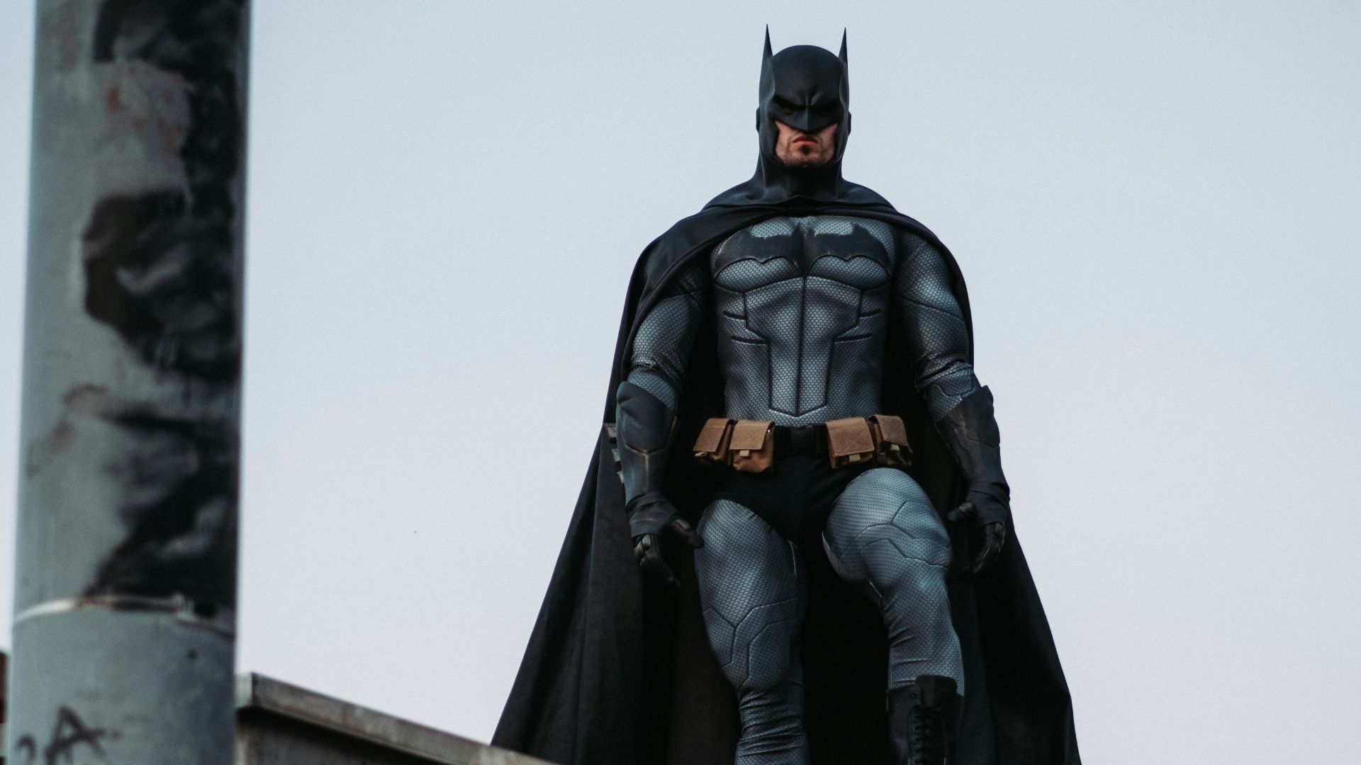man in black jacket and pants standing on roof