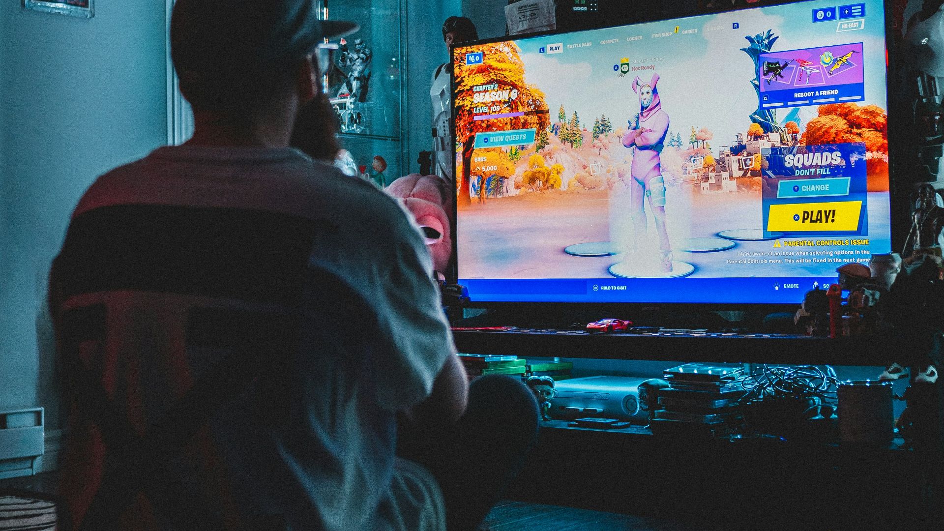 man in red shirt watching tv