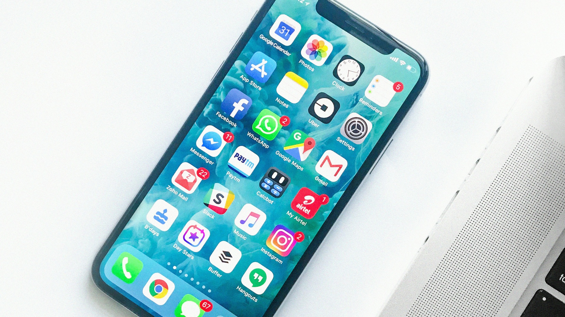 white smartphone near laptop