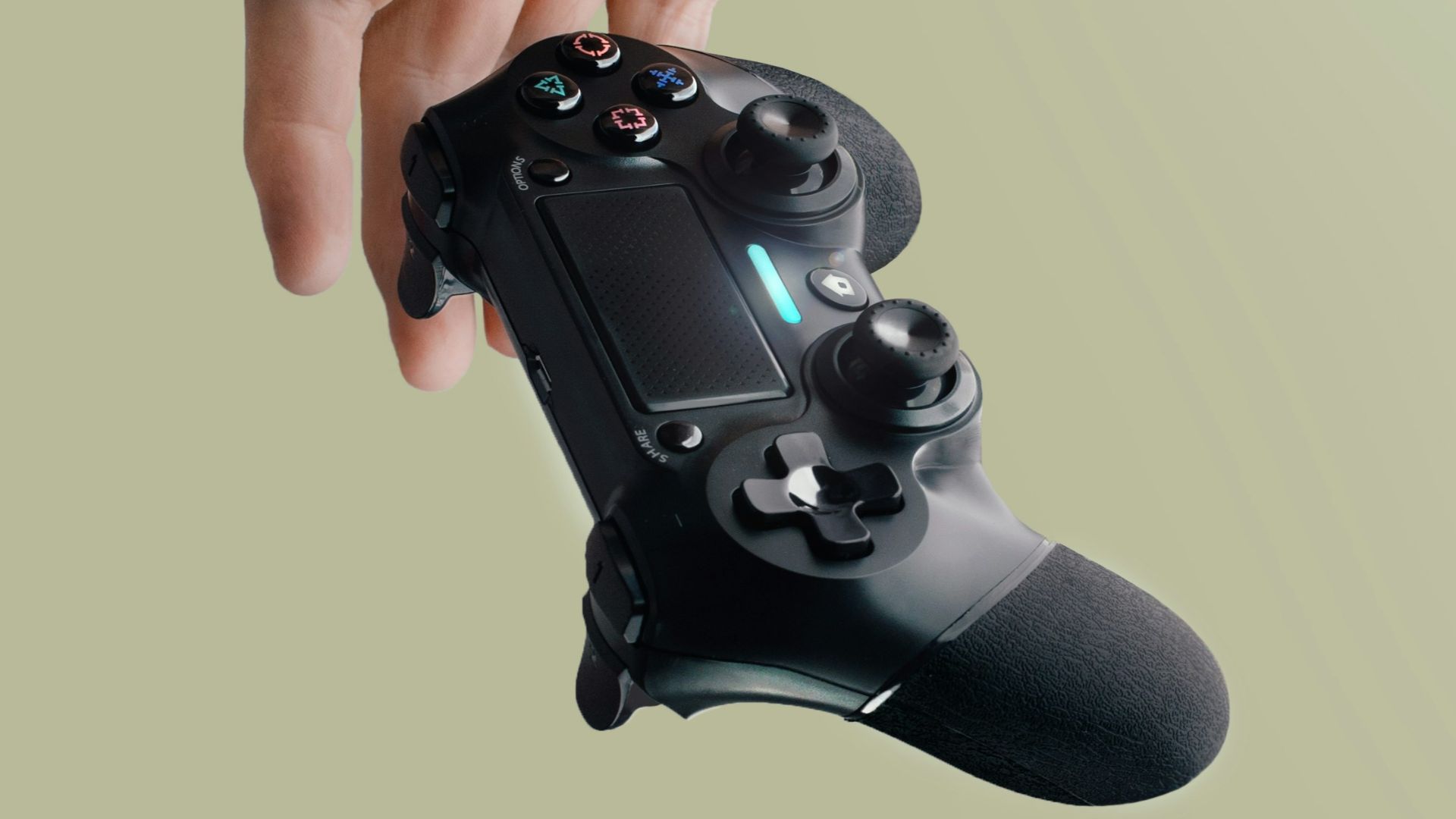 person holding Sony DualShock 4 wireless controller