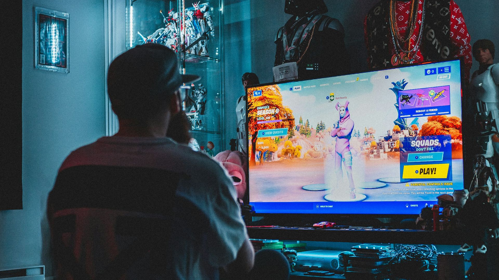 man in red shirt watching tv