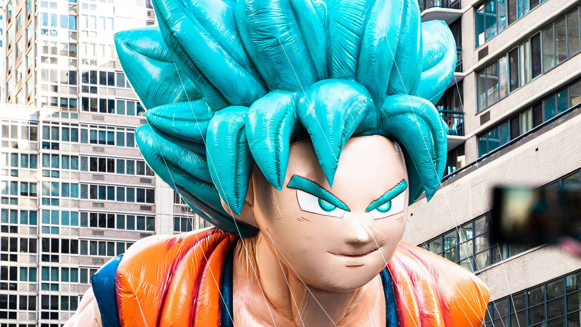 a large balloon of a dragon is being held up in the air