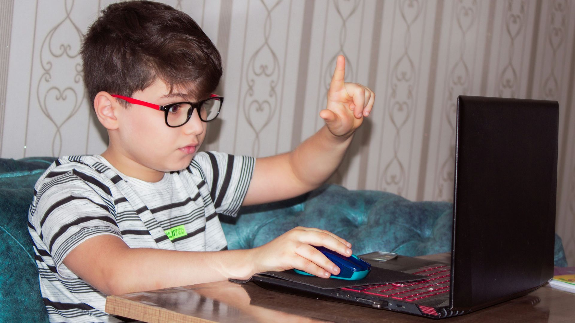 man in black and white stripe shirt using black laptop computer