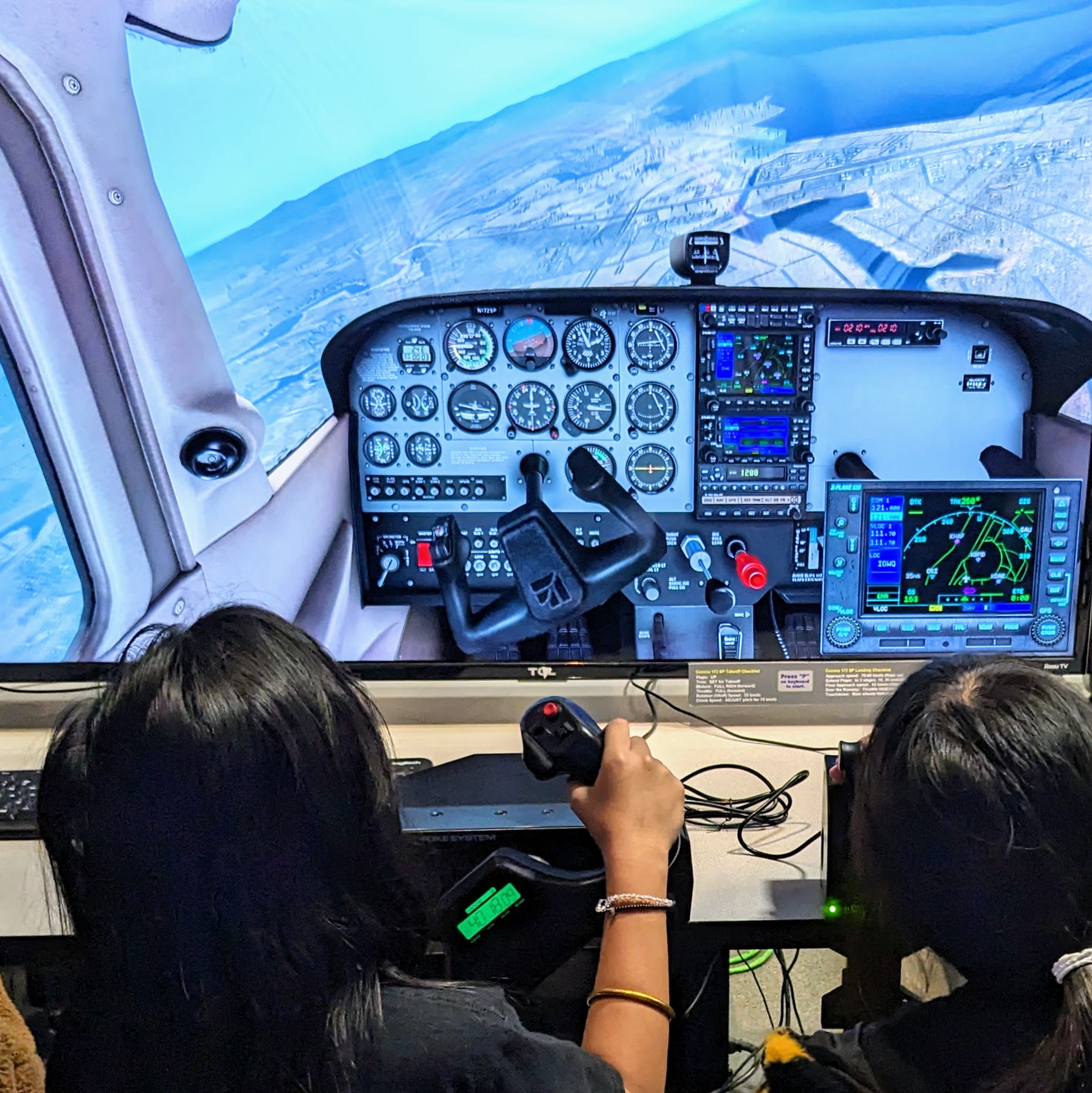 Visitors_using_a_desktop_flight_simulator_at_Hiller_Aviation_Museum-2.jpg