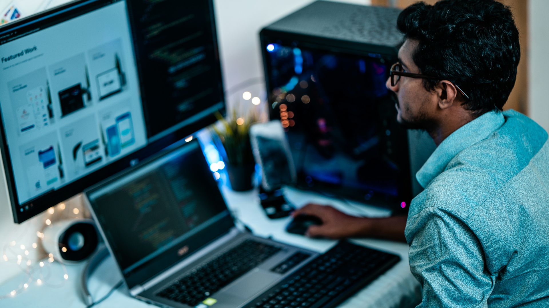 man in blue dress shirt using computer