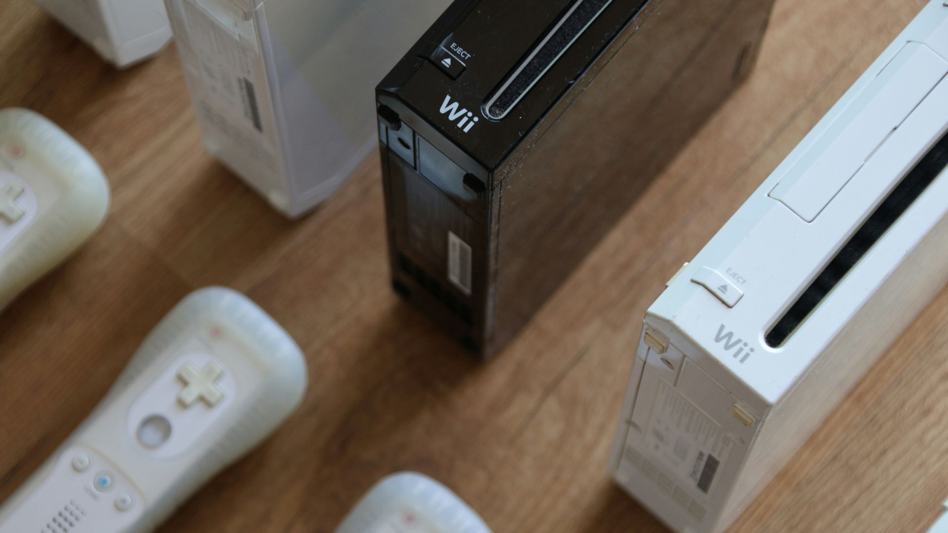 a group of video game controllers sitting on top of a wooden table