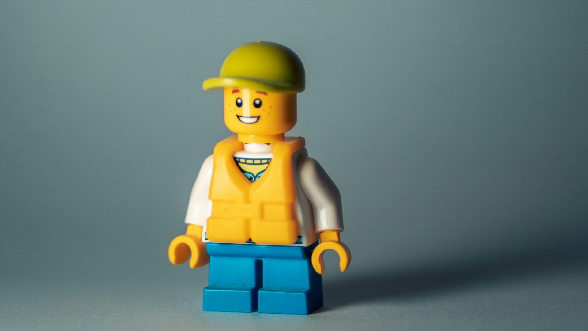 yellow lego minifig on white surface