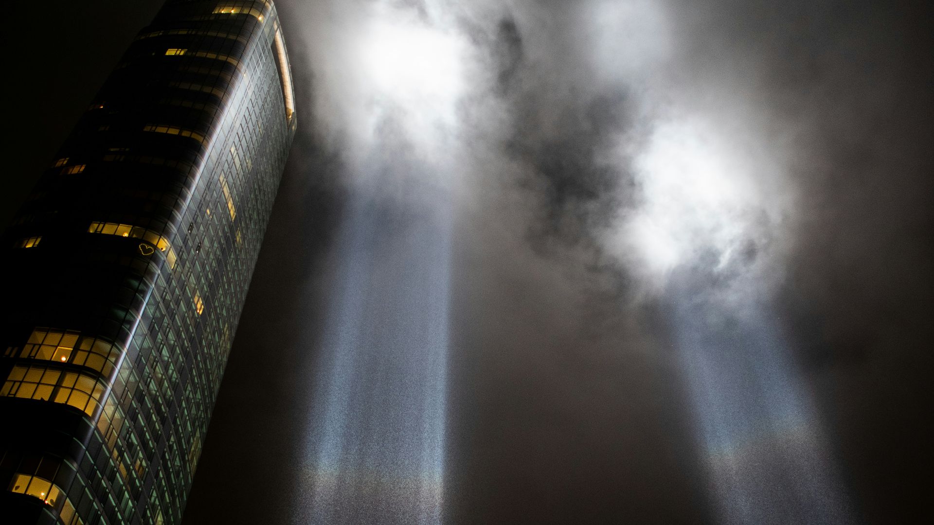 a very tall building with two beams of light coming out of it