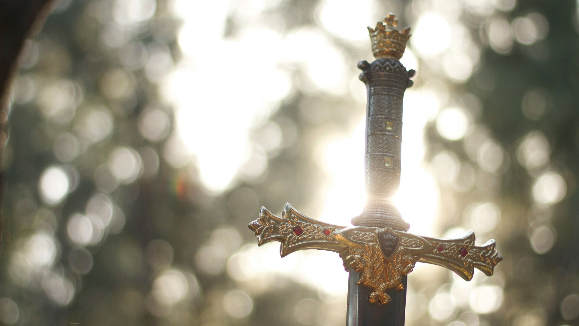 close-up photography of gold-colored and black sword