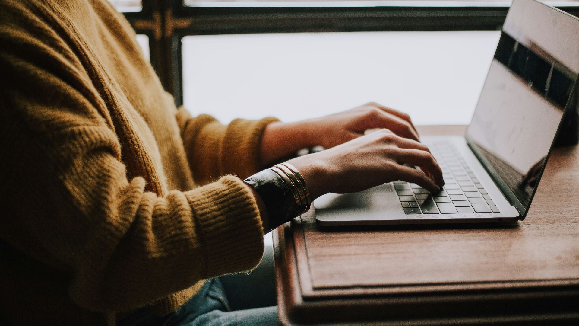 person sitting front of laptop