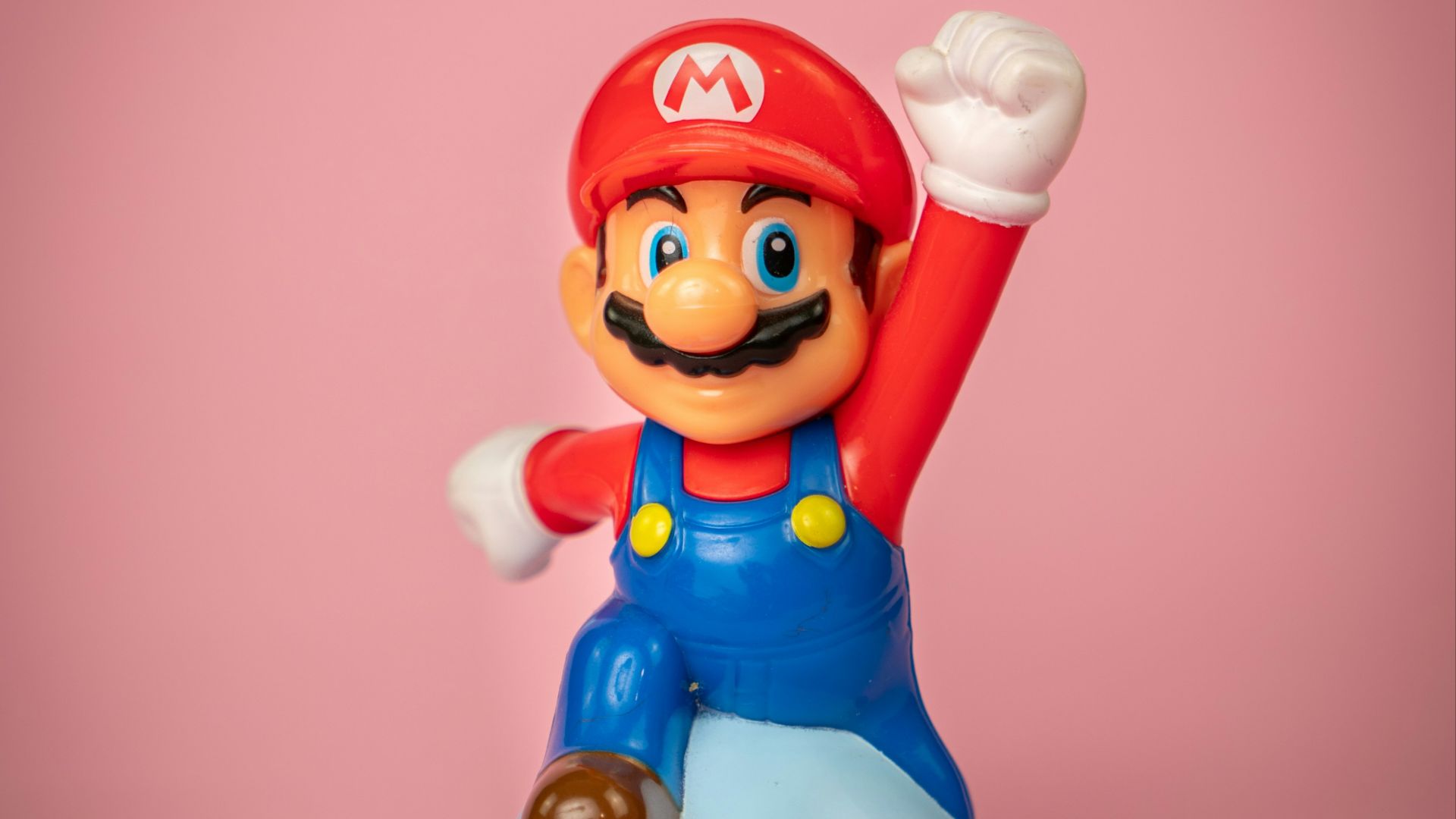 a toy figure of mario on top of a blue object