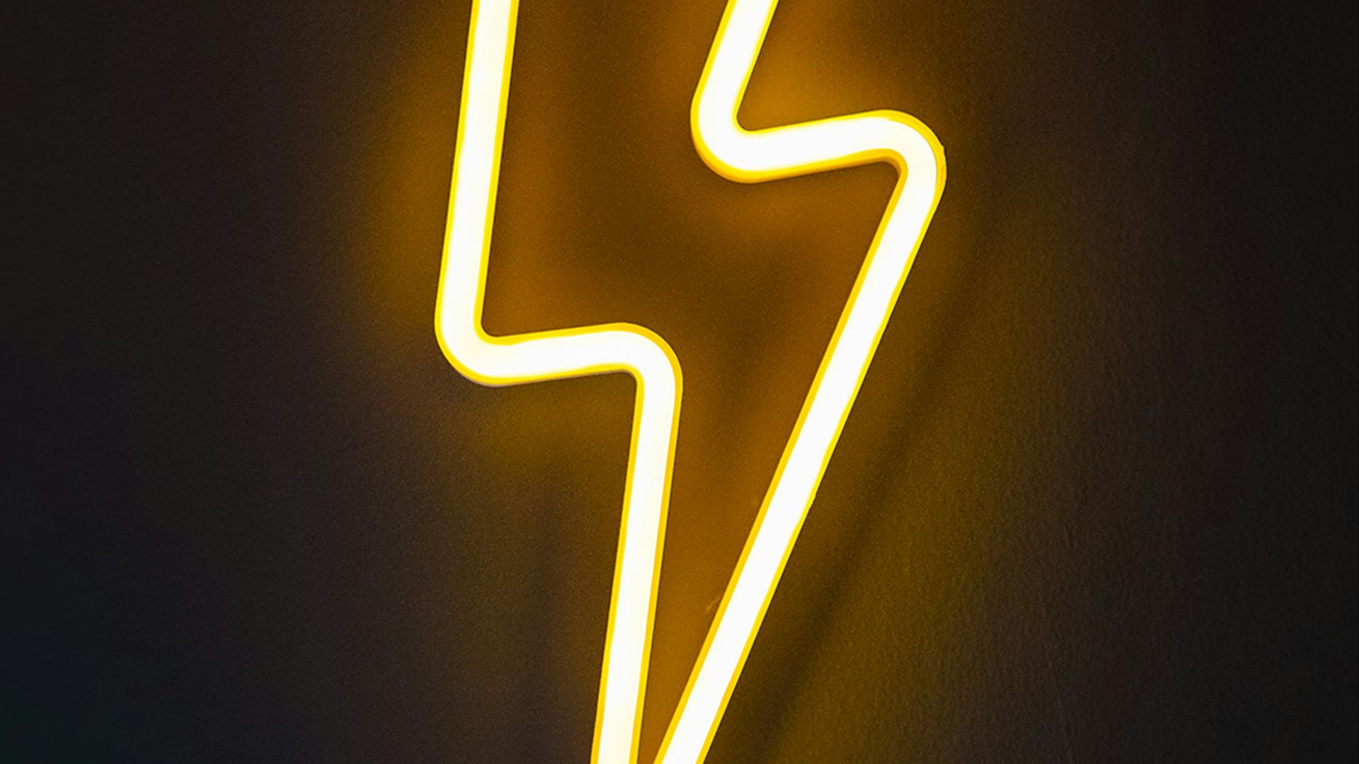 white light bulb turned on in dark room