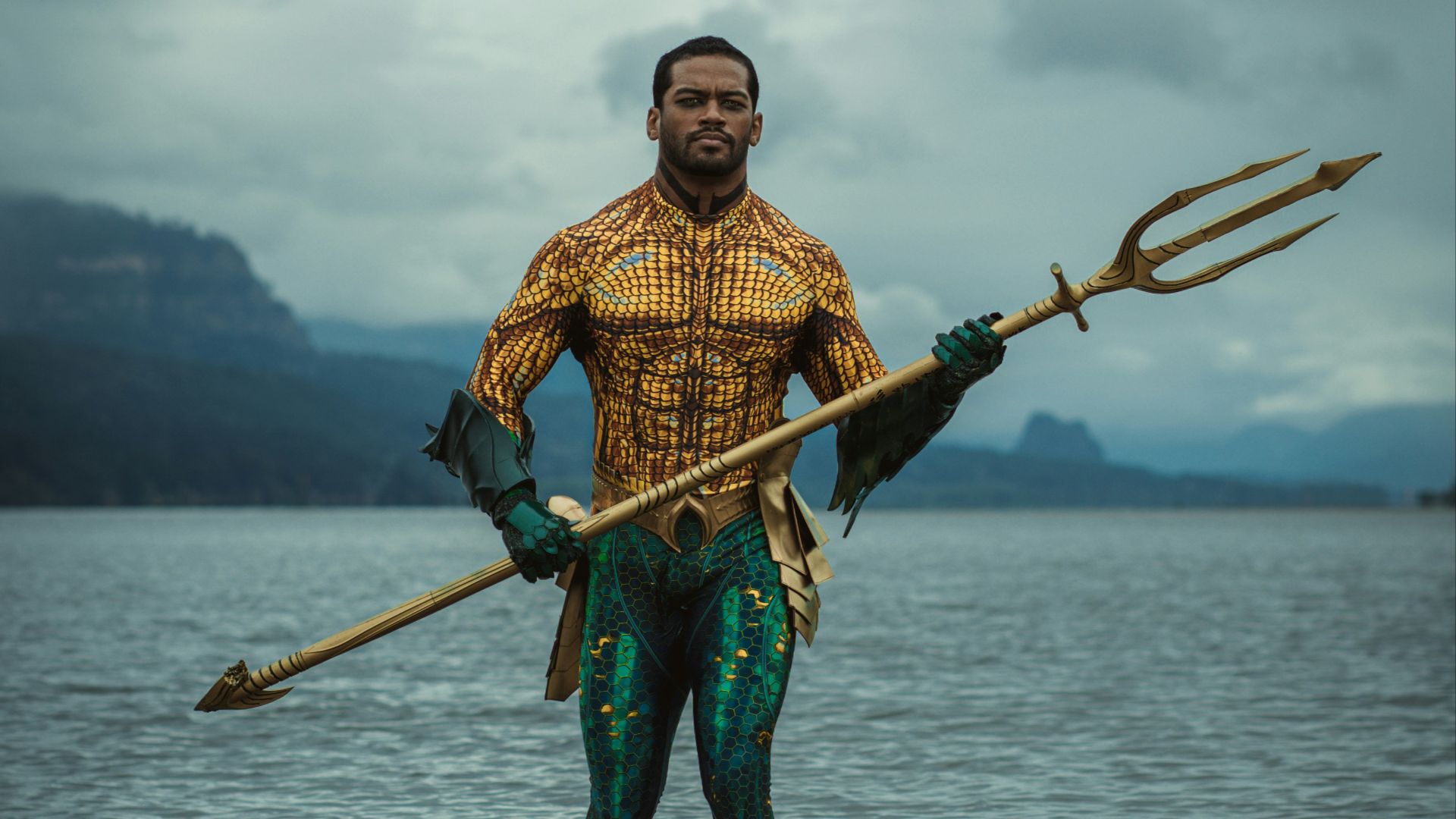 a man standing in a body of water holding a spear