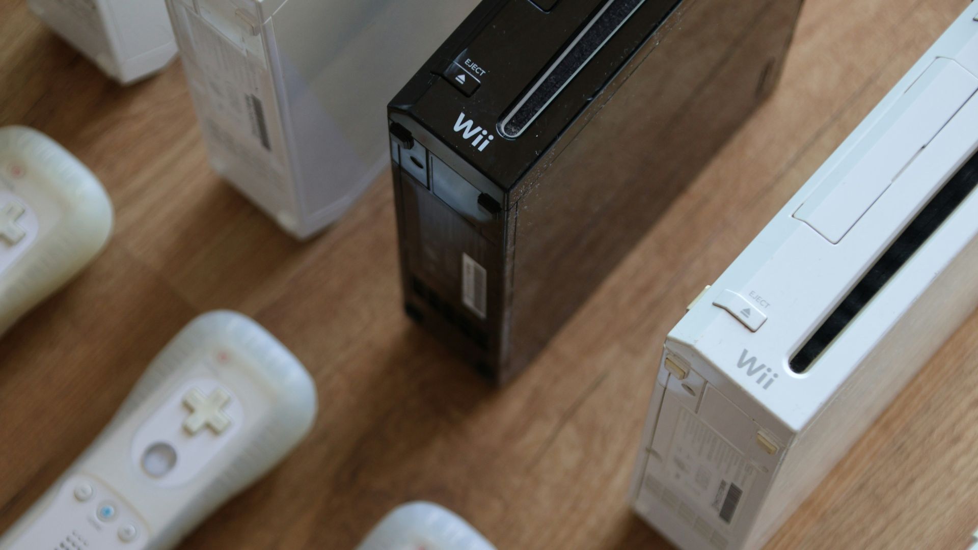a group of video game controllers sitting on top of a wooden table
