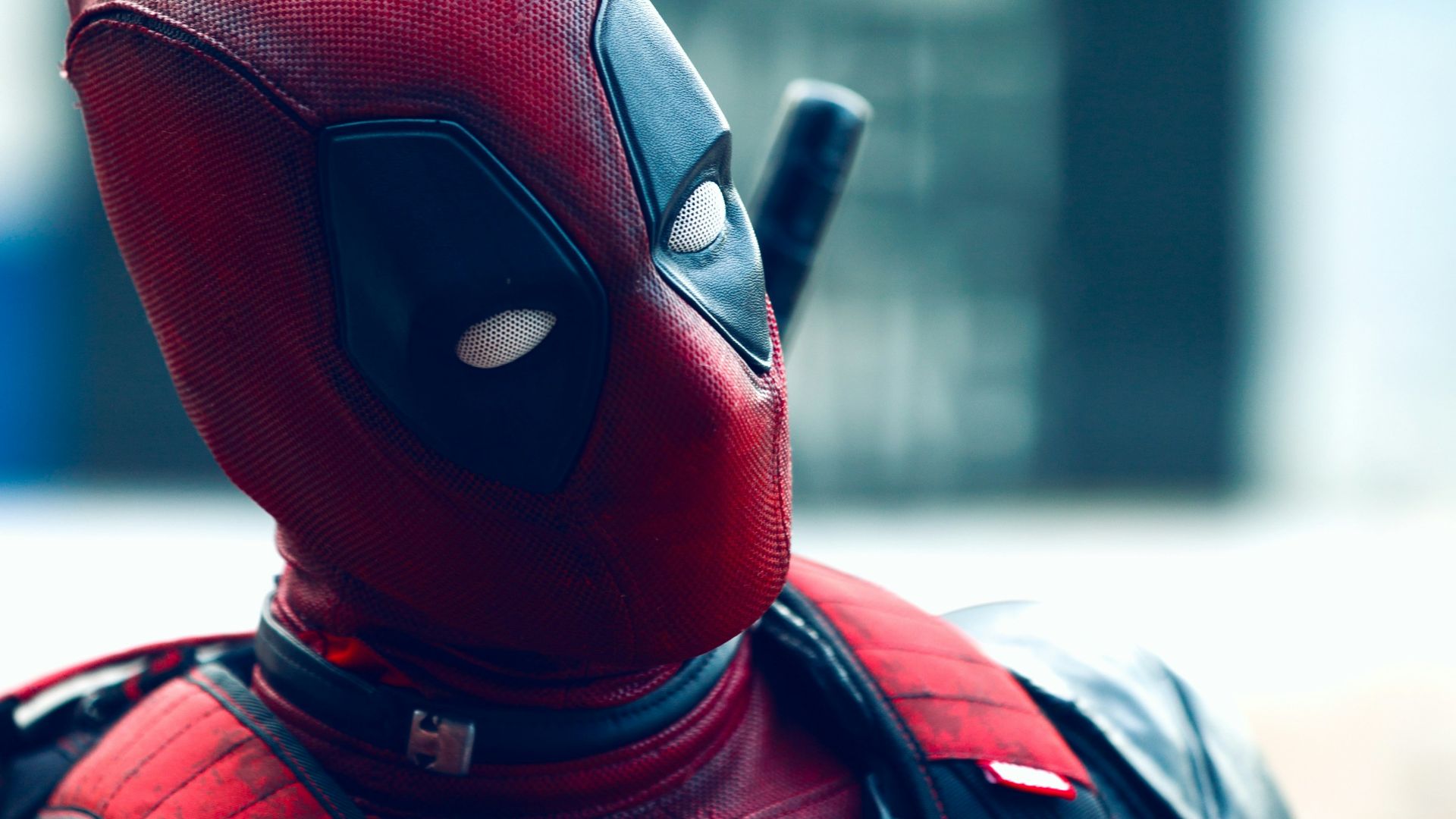 a man in a deadpool costume with a knife in his hand