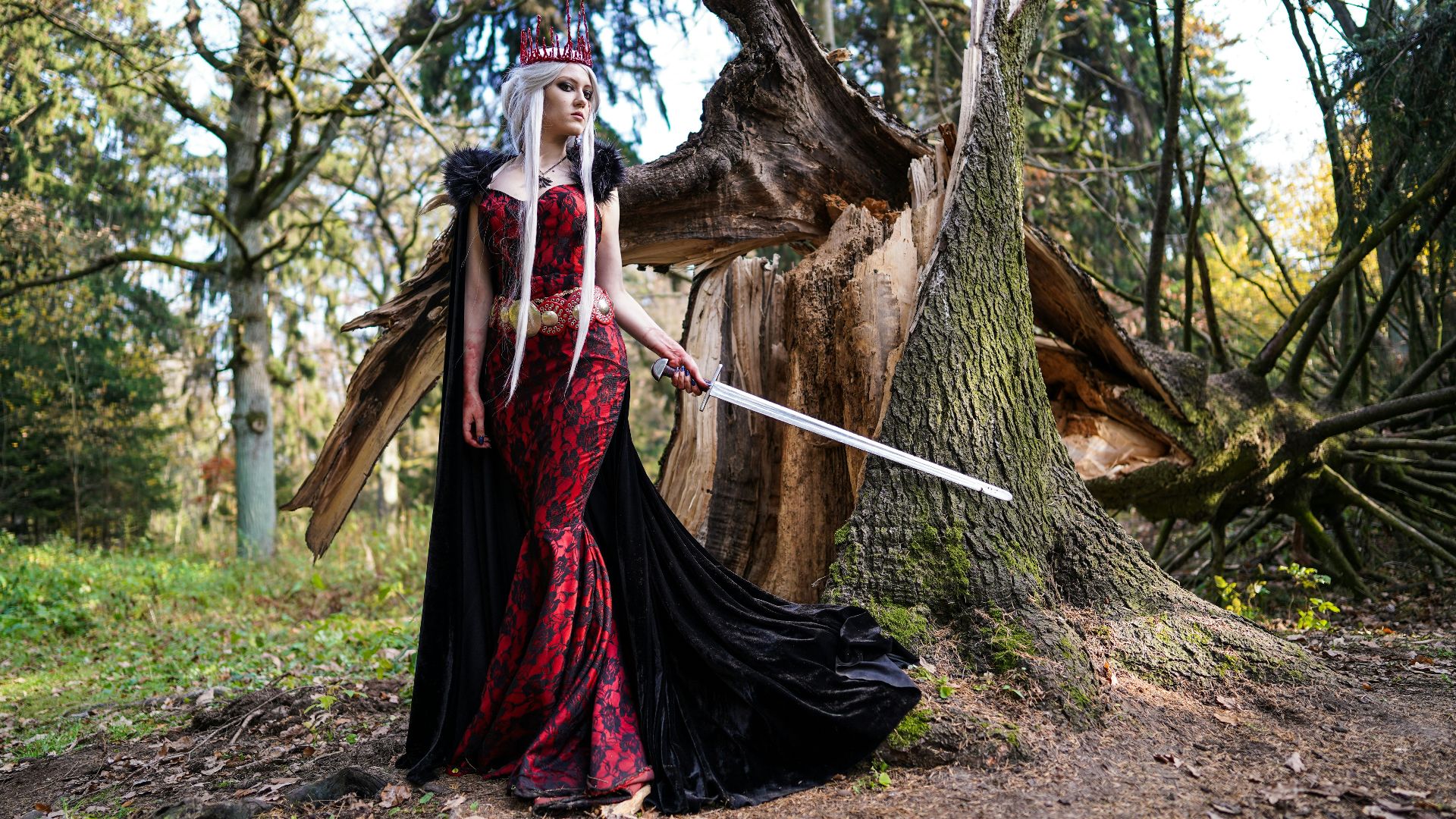 woman wearing red dress holding sword