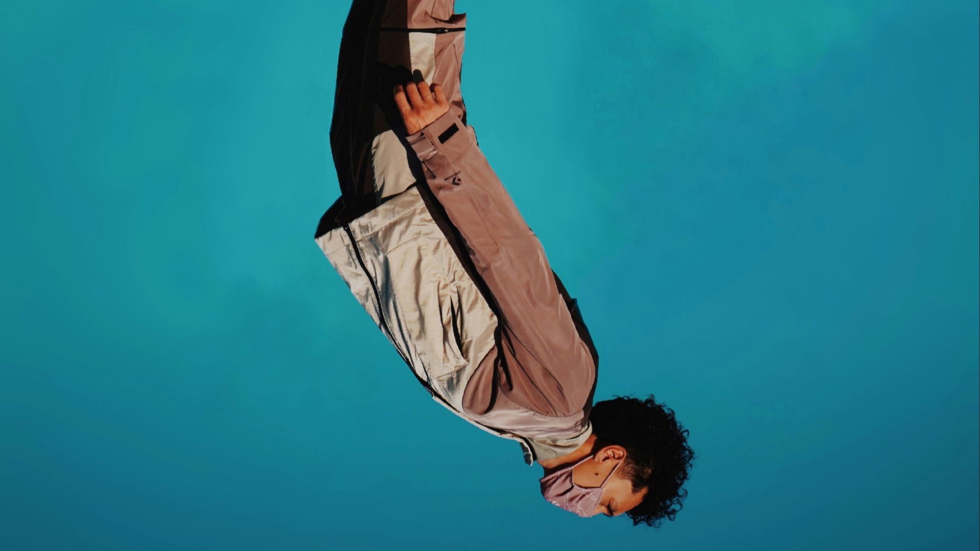 man in brown jacket and black pants