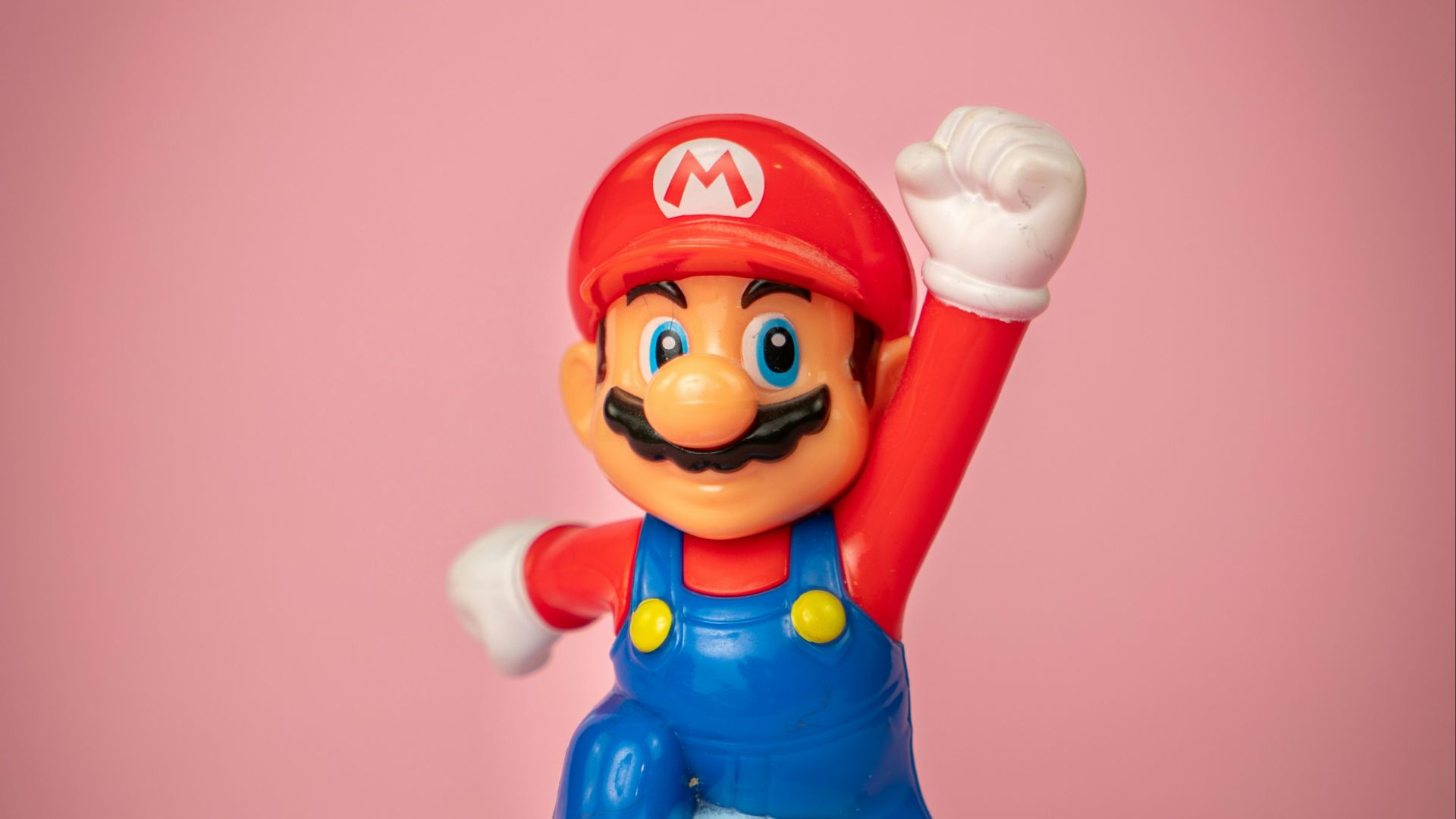 a toy figure of mario on top of a blue object