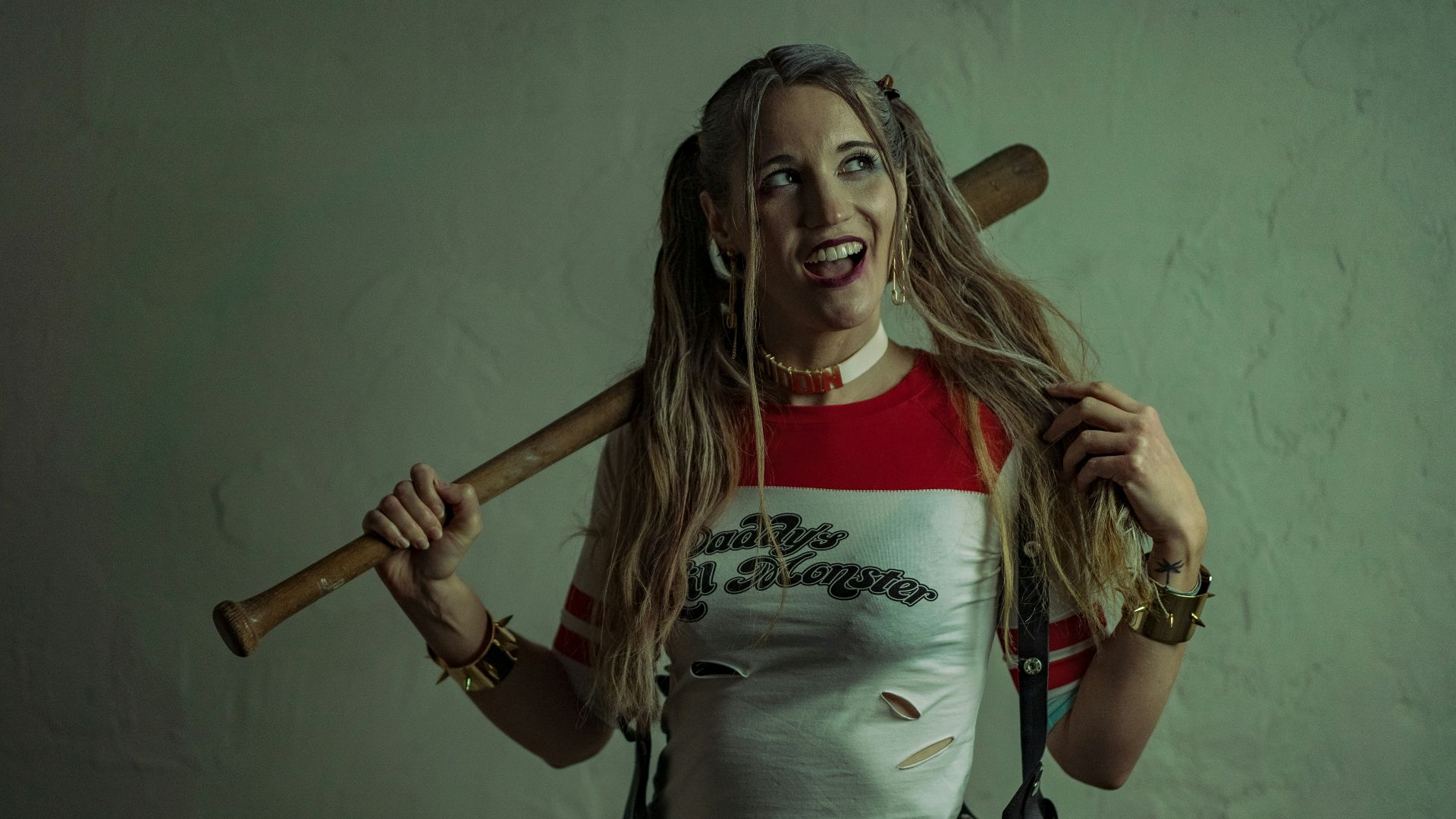 woman in white and red adidas crew neck t-shirt holding brown wooden baseball bat