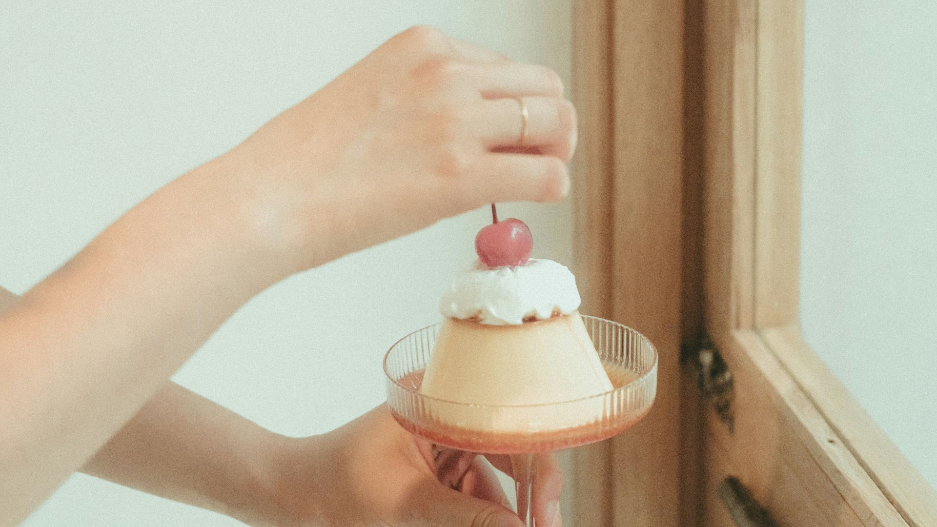 person holding pink and white plastic toy