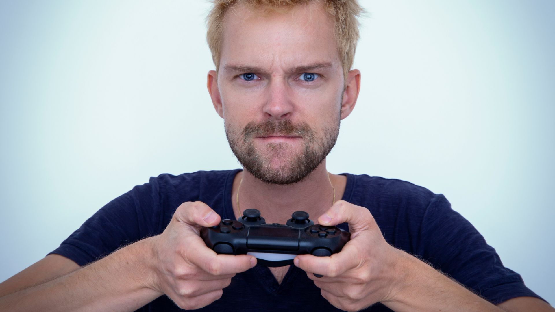man in blue long sleeve shirt holding black semi automatic pistol