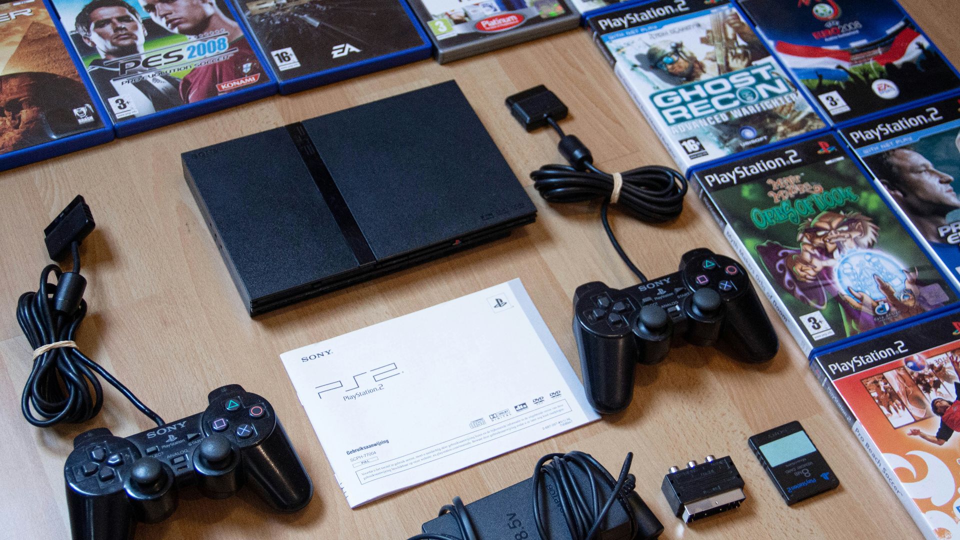 black sony ps 4 game controller on brown wooden table