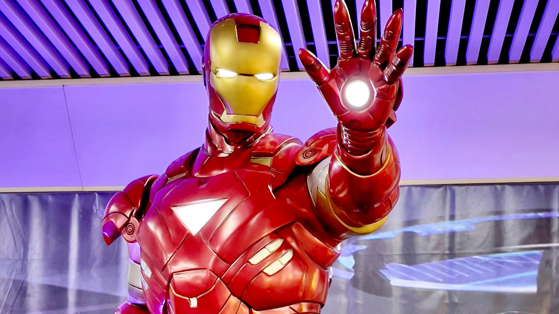 a statue of iron man is displayed in a museum