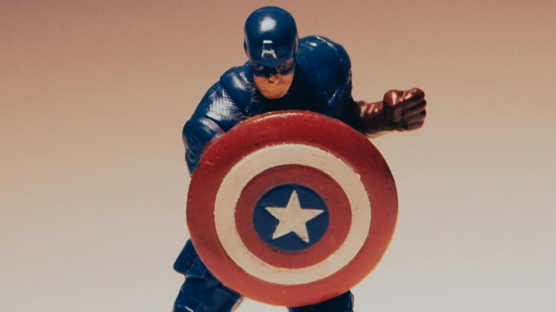 a toy of a captain america holding a shield