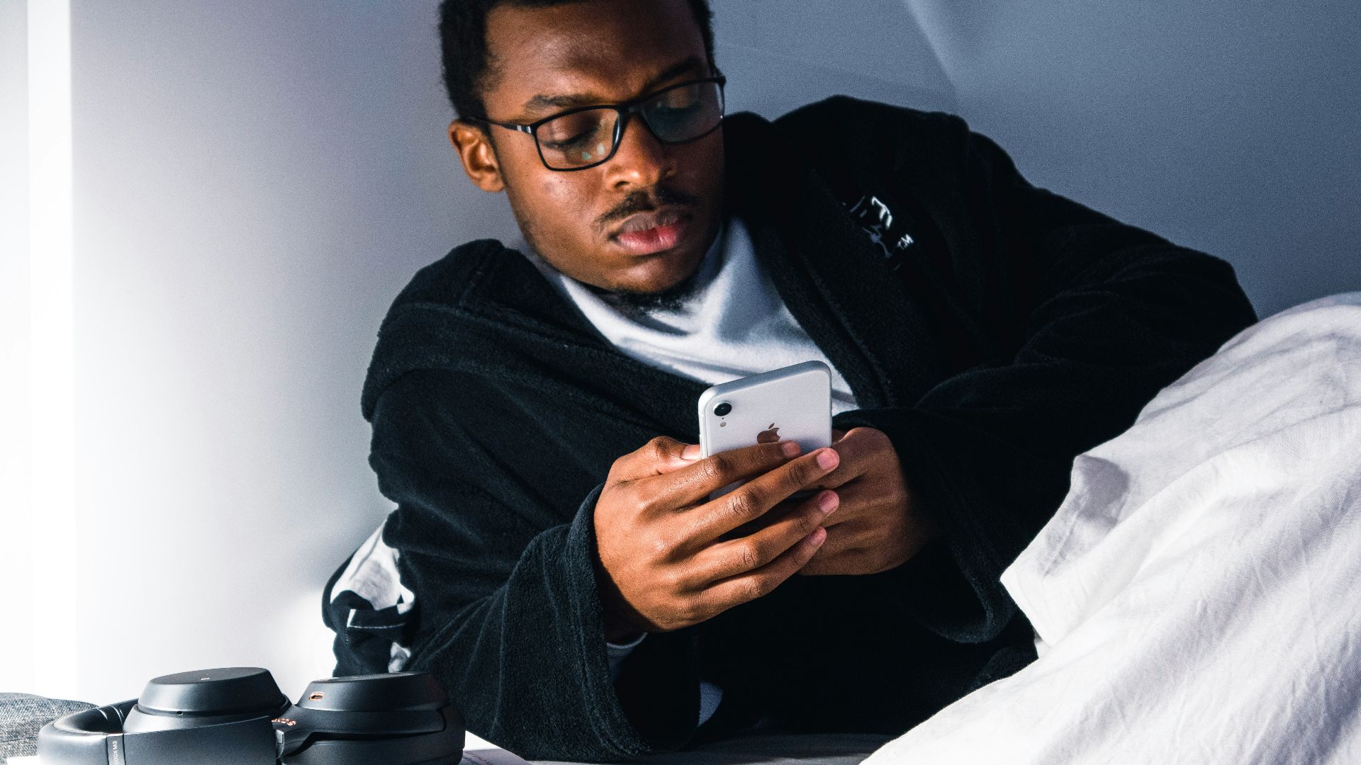 man in black jacket wearing black framed eyeglasses