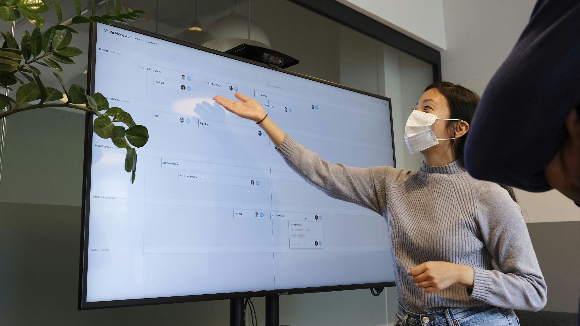 man in white and black checked dress shirt holding white printer paper