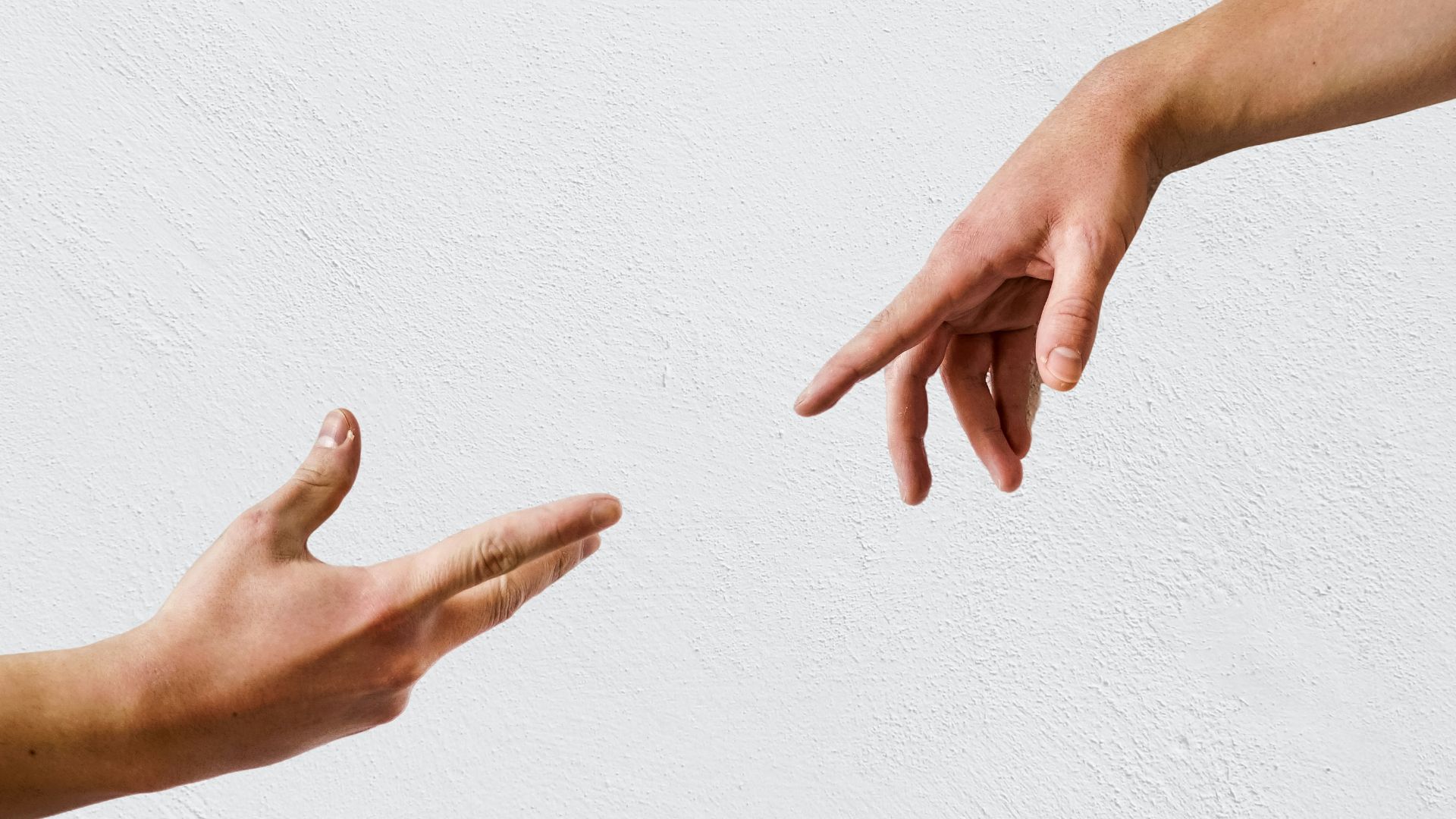 persons hand on white wall