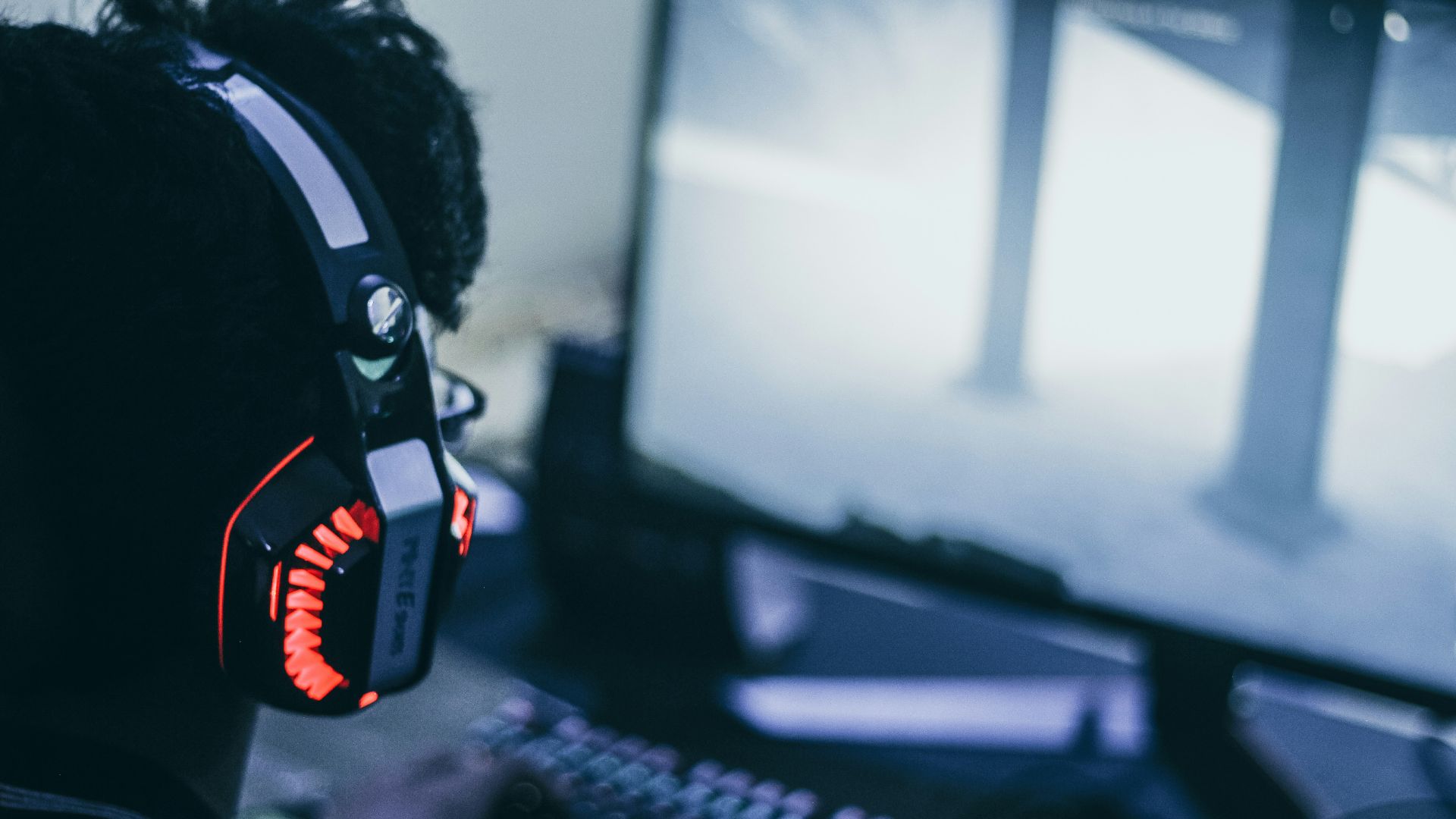 person wearing orange and black headphones