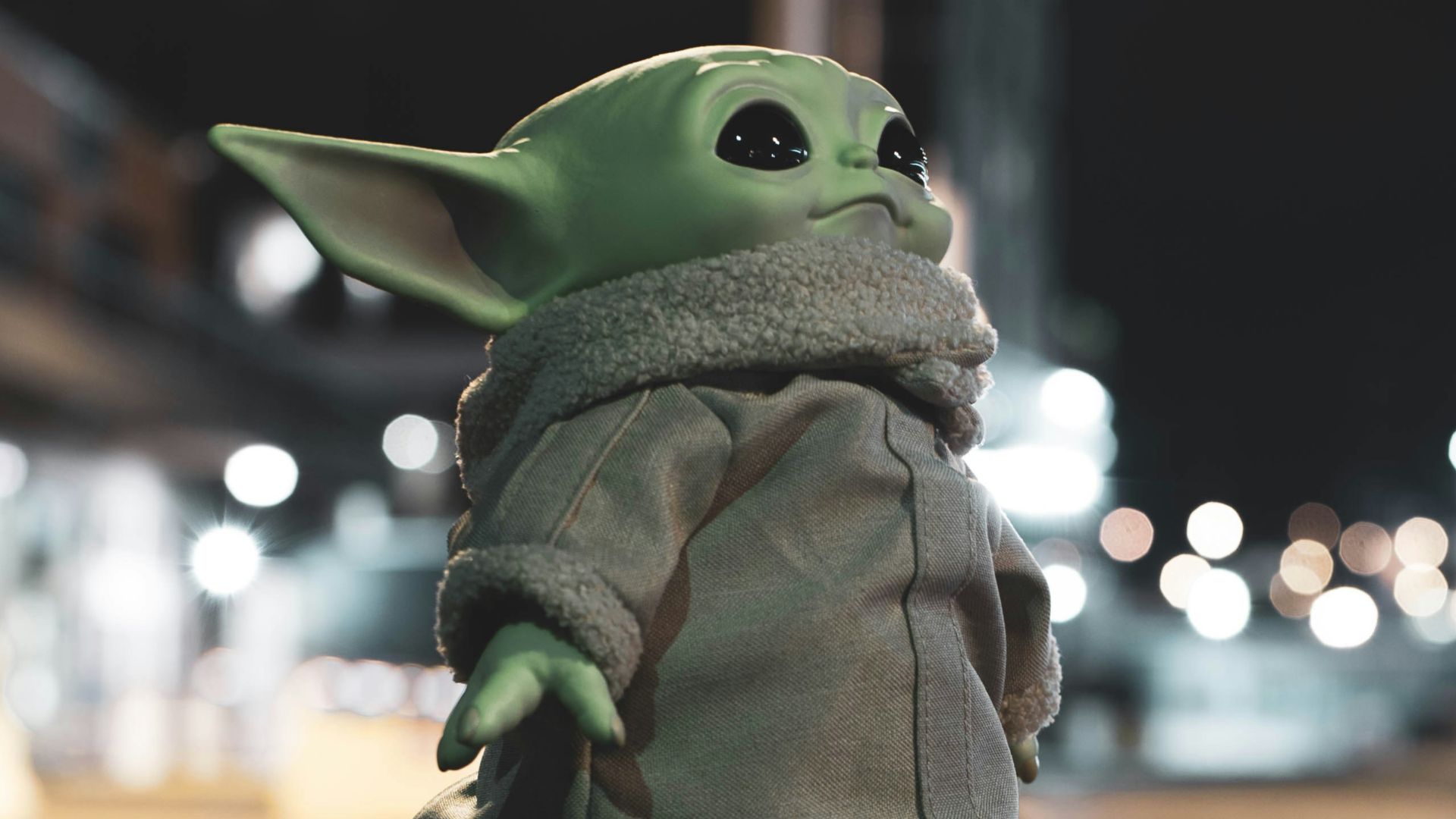 green frog figurine on brown marble table