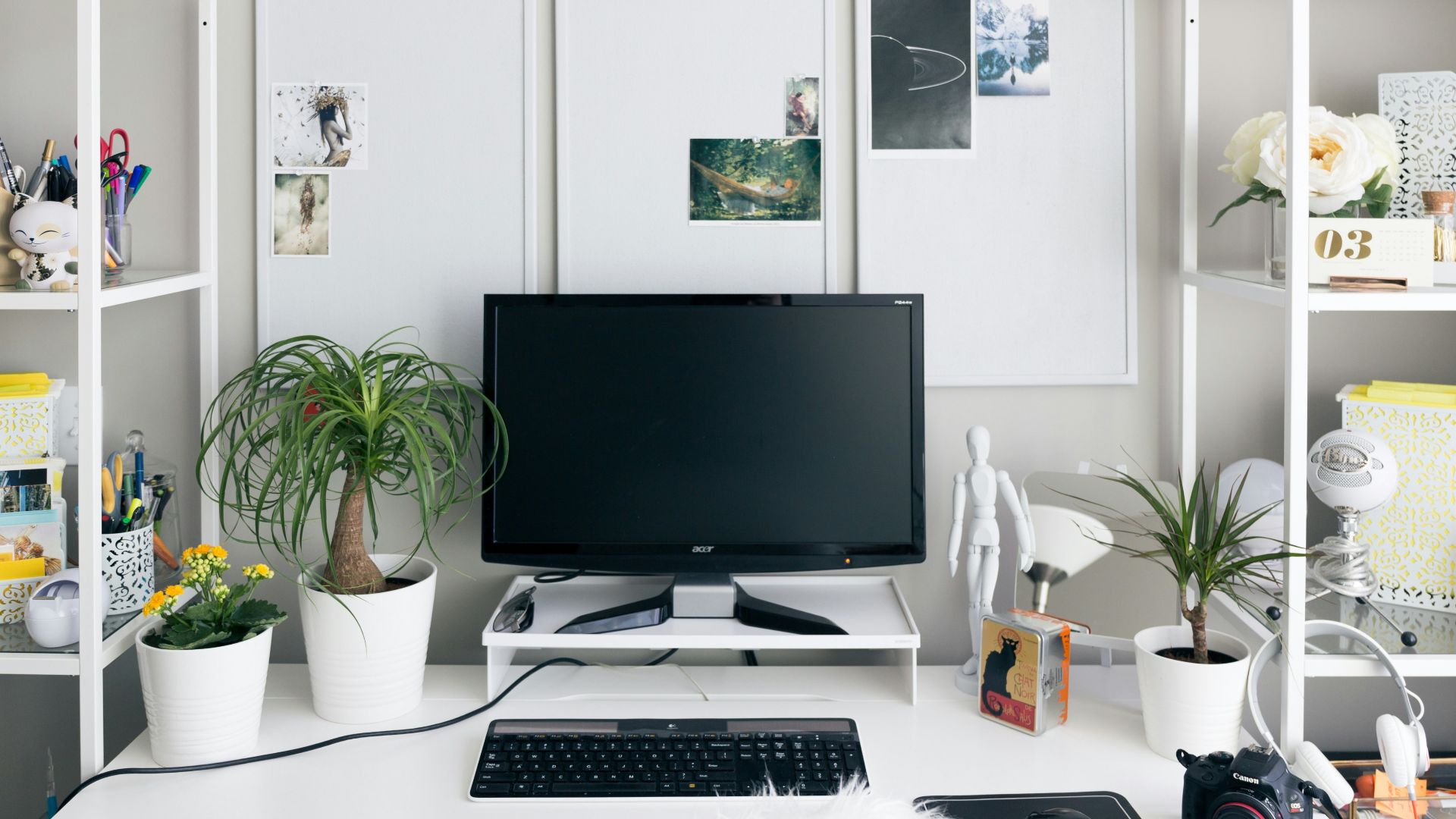 computer setup on white wooden table inside room