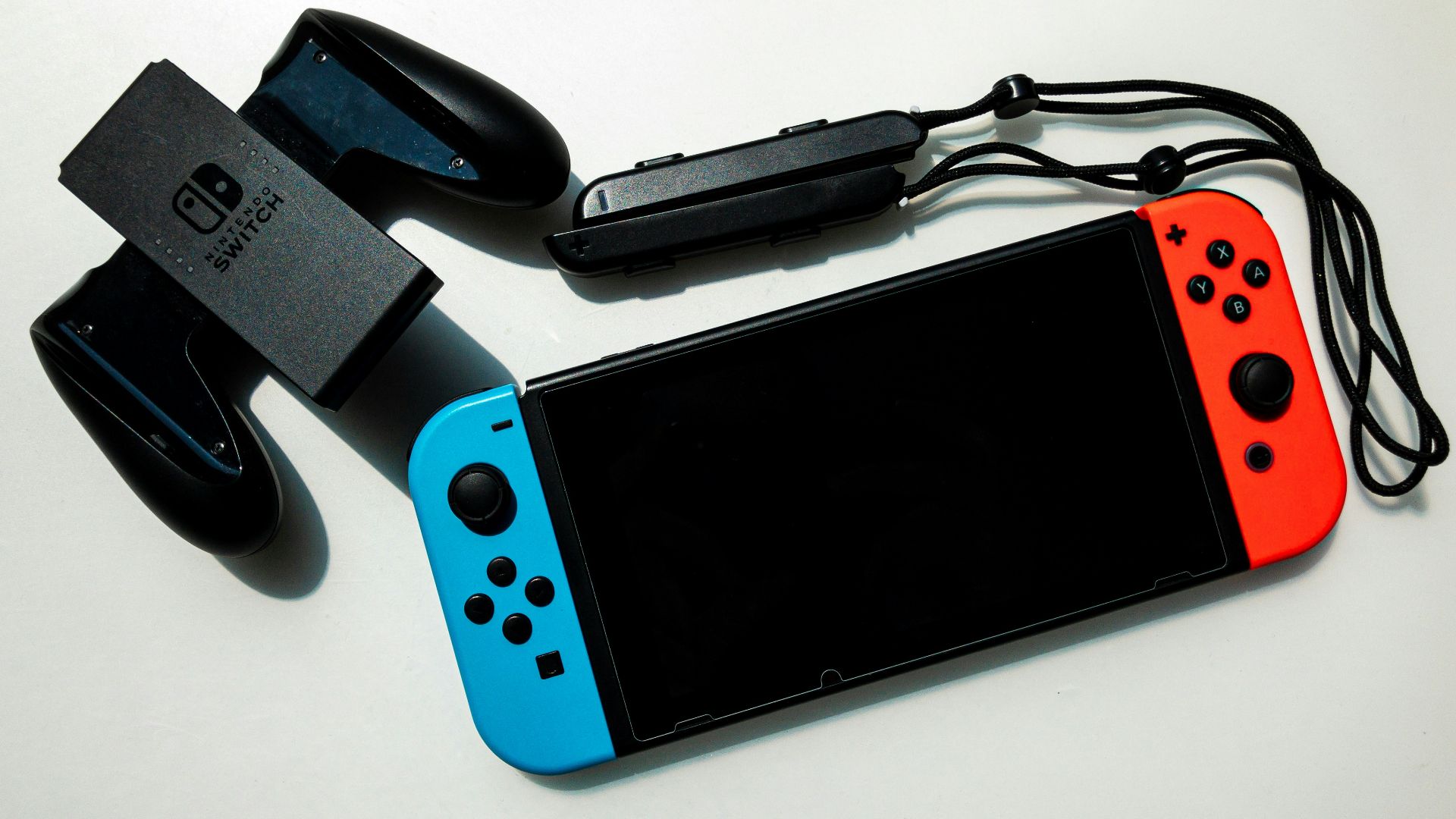 white nintendo switch beside black usb flash drive