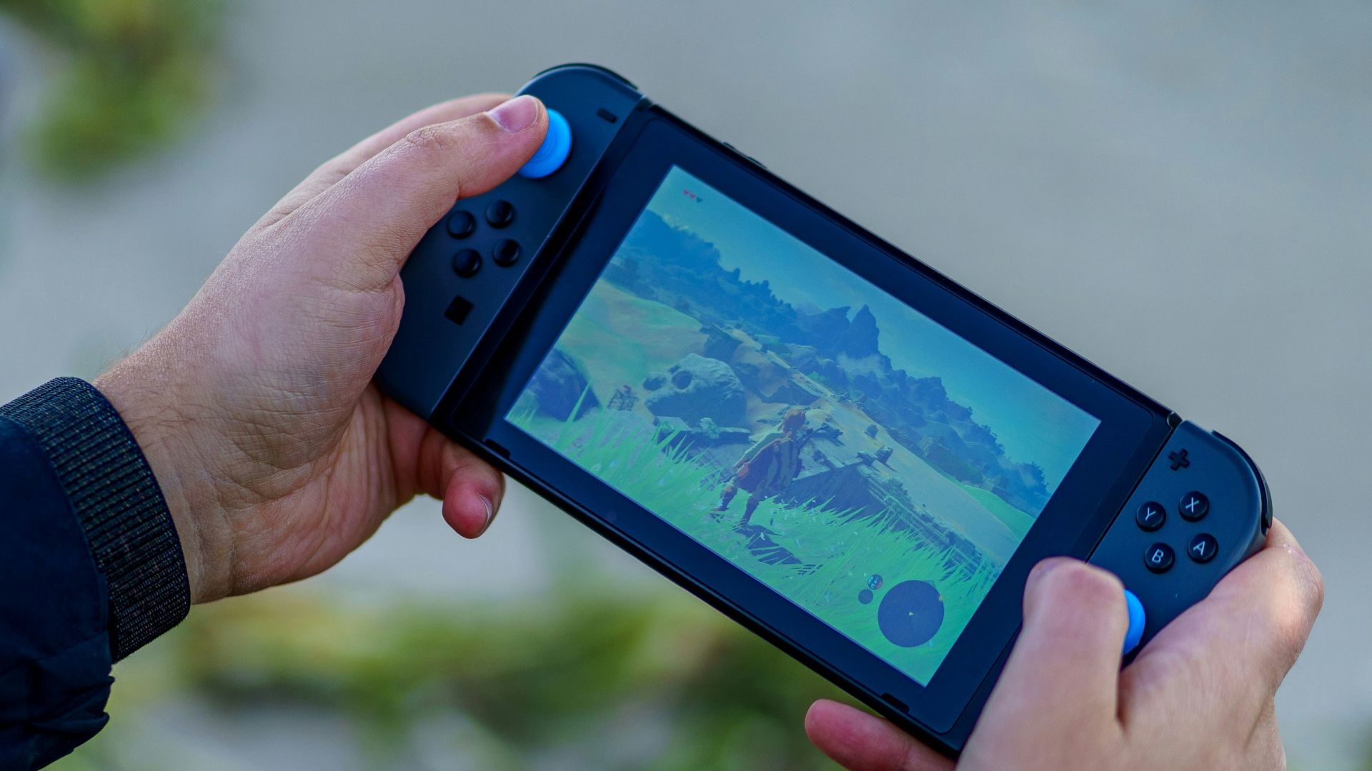 a person is playing a video game on a cell phone