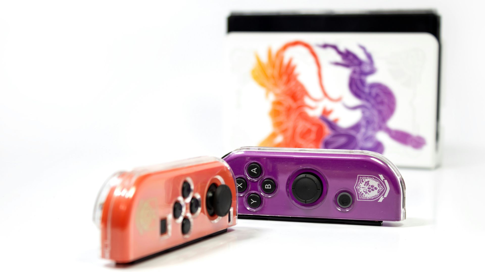 a purple and red camera sitting next to each other