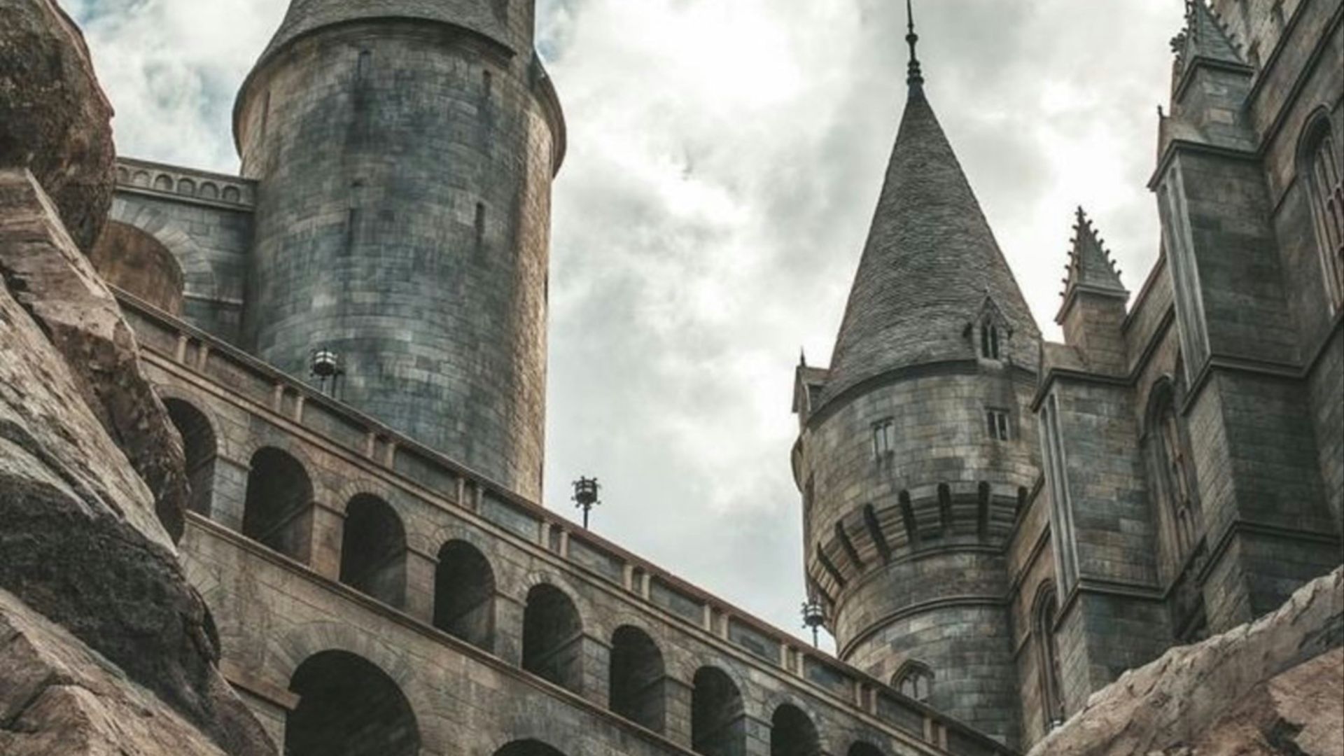 white clouds hovering above grey castle