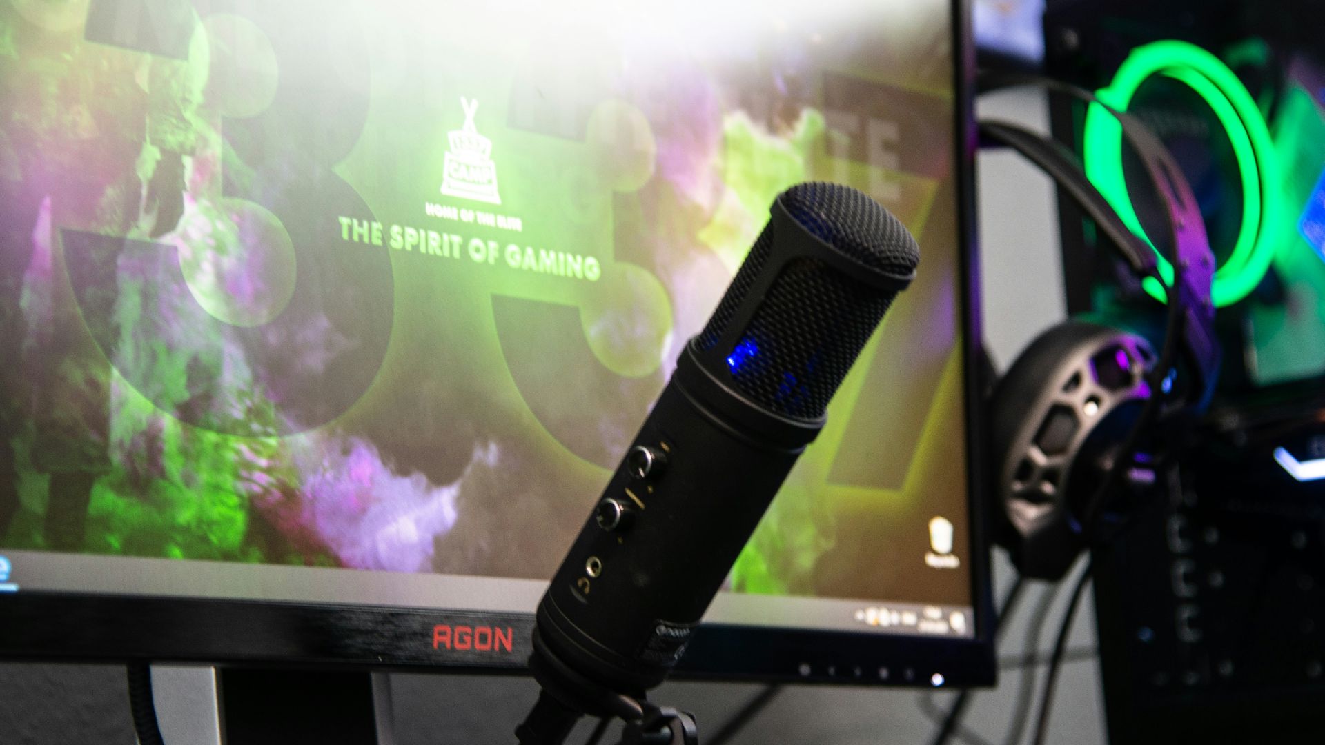 black microphone beside black flat screen computer monitor