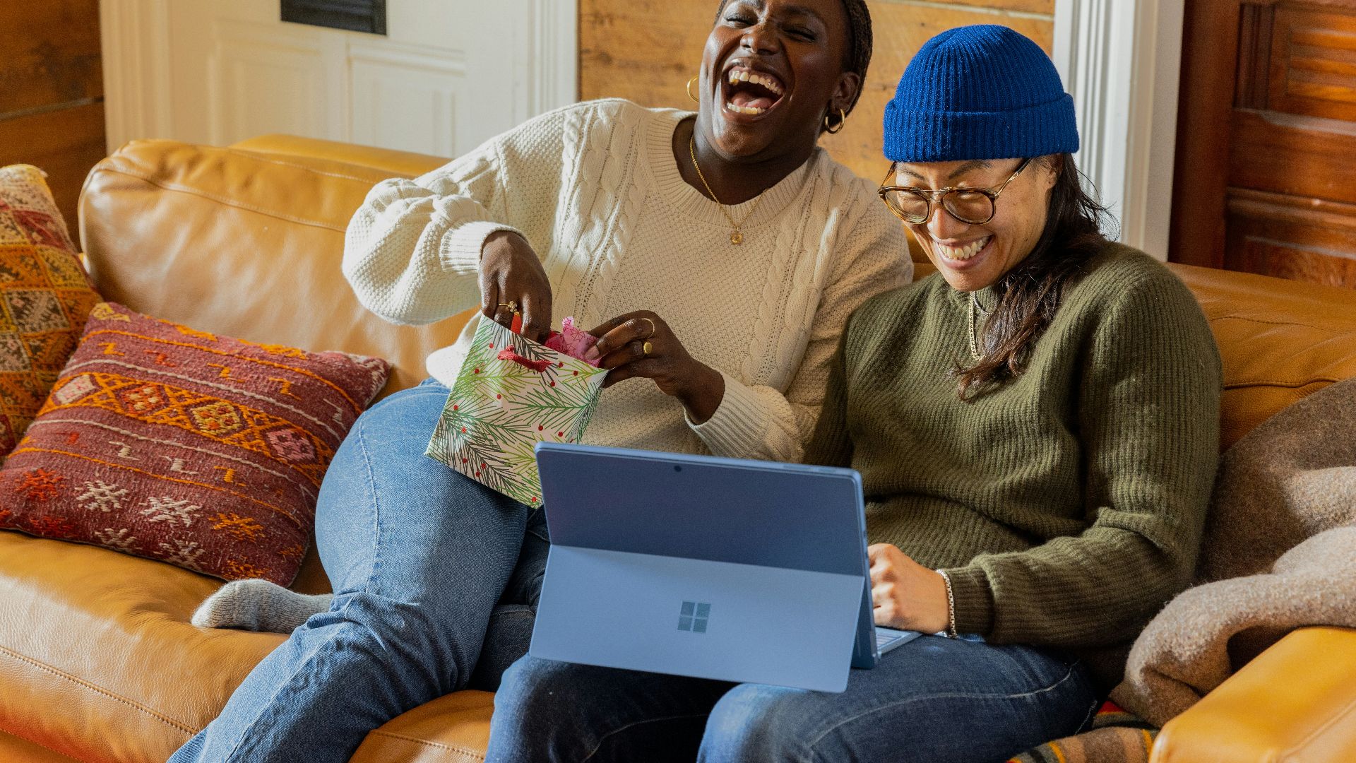 a person sitting on a couch with a laptop